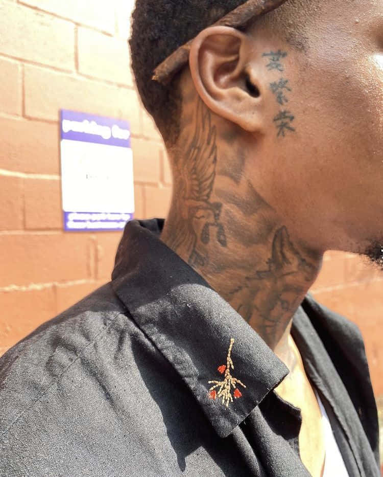 A Man With Tattoos On His Neck
