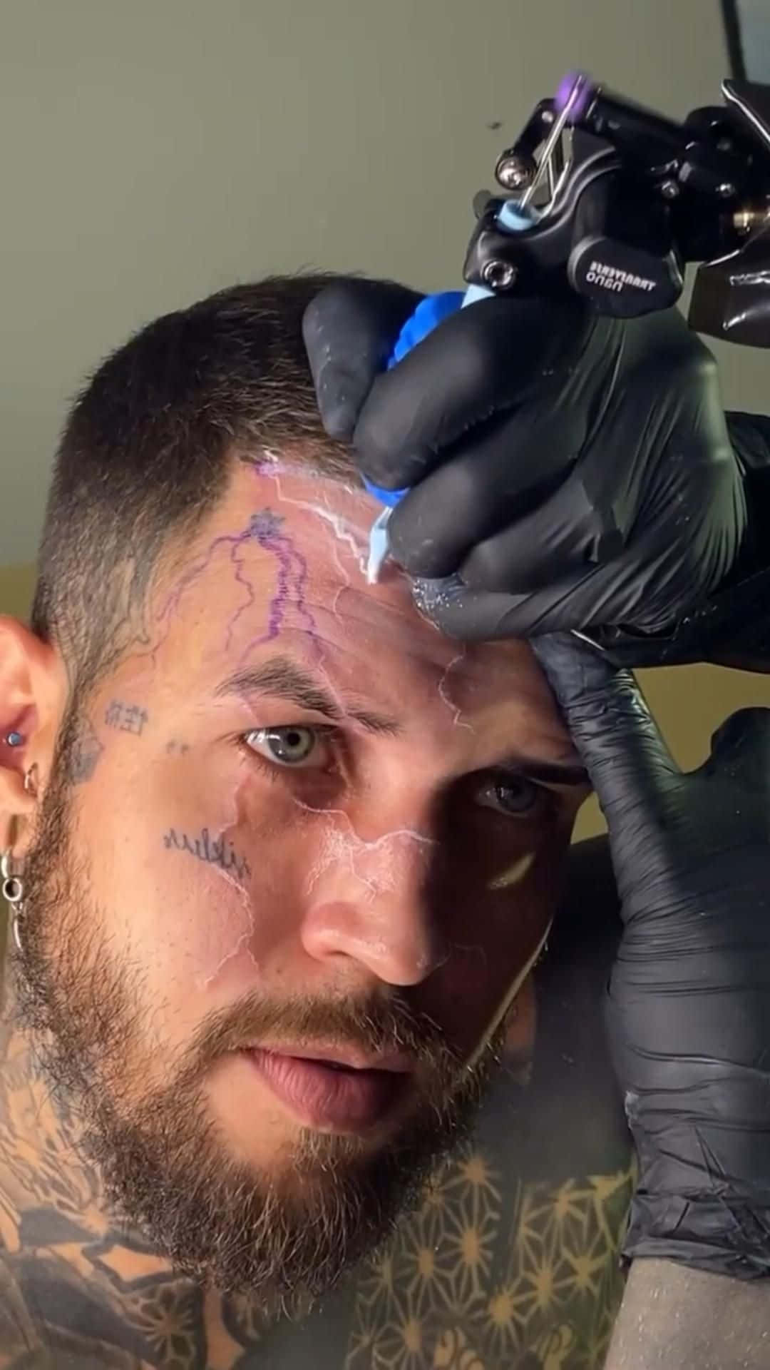 A Man Getting Tattooed On His Head