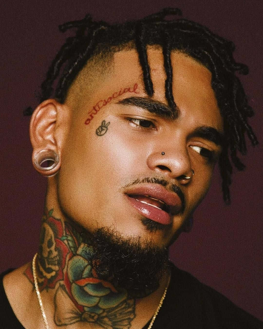 A Man With Tattoos On His Neck