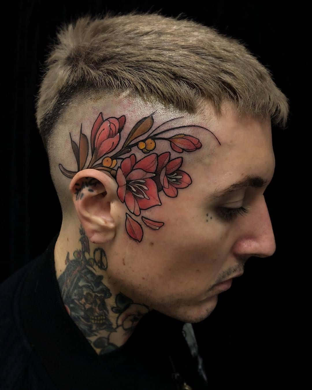 A Man With A Flower Tattoo On His Head