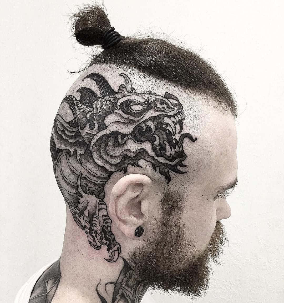 A Man With A Dragon Tattoo On His Head