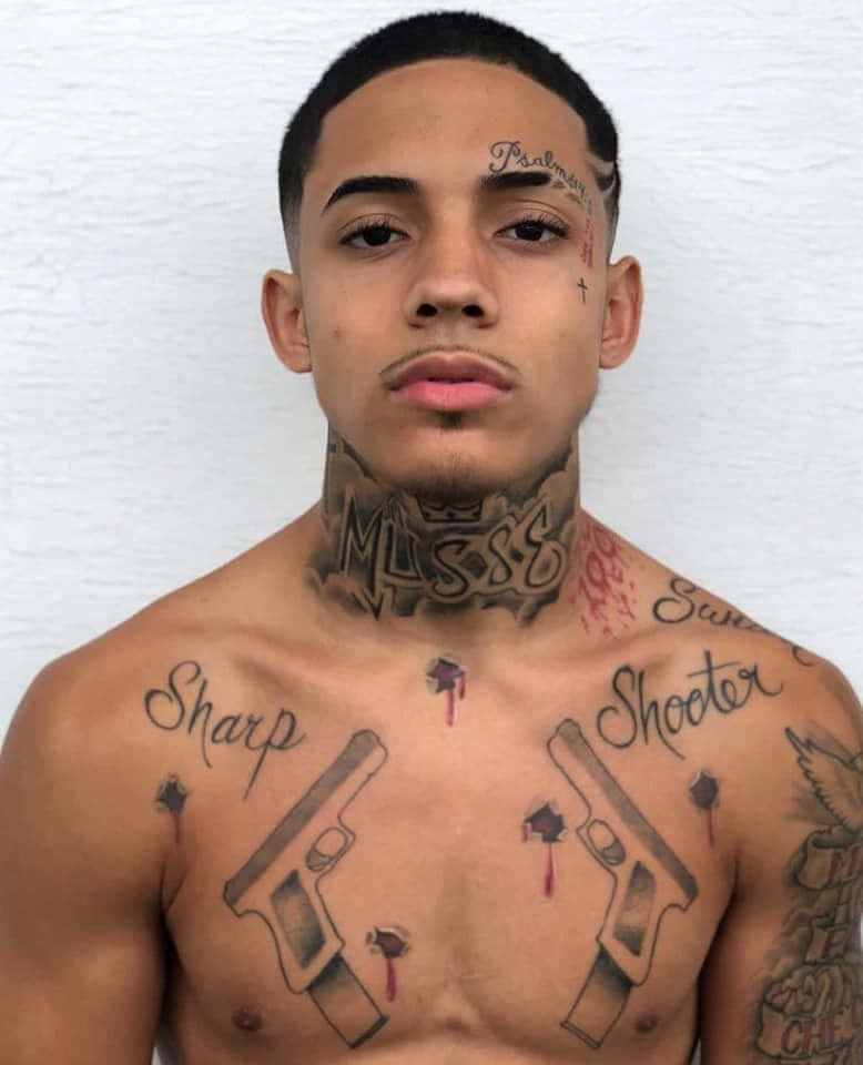 Download A Young Man With Tattoos On His Chest
