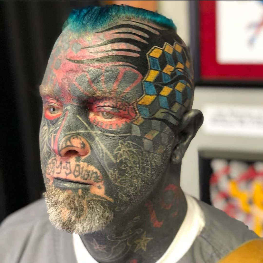 A Man With A Tattoo On His Face