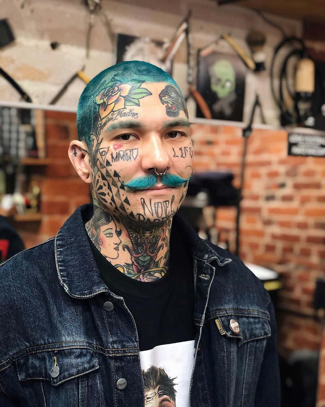 A Man With A Green Hair And Mustache In A Tattoo Shop