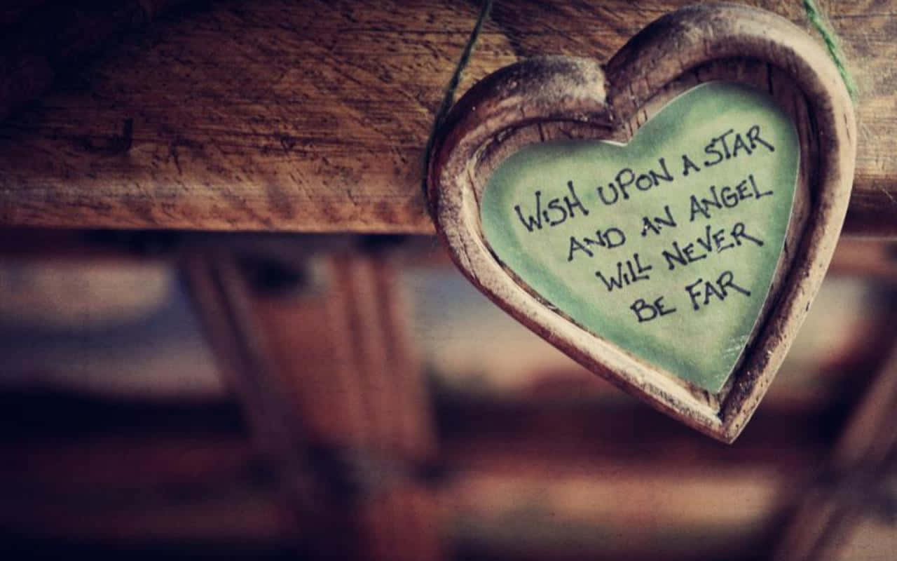 A Heart Shaped Wooden Plaque With A Quote Hanging On It