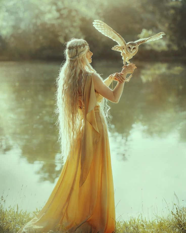 A Woman In A Yellow Dress Holding An Owl