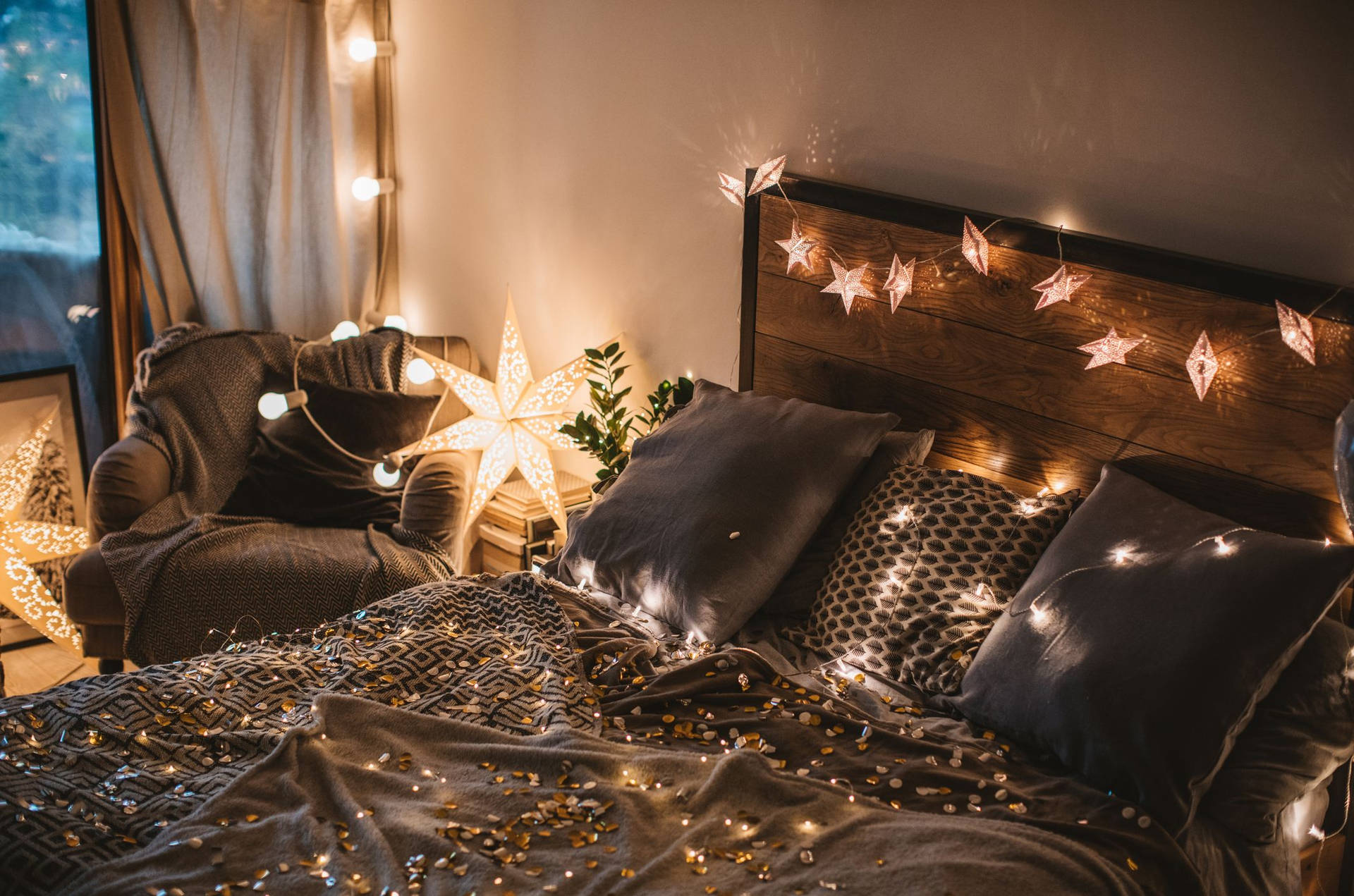 A Bed With Christmas Lights And A Lamp Wallpaper
