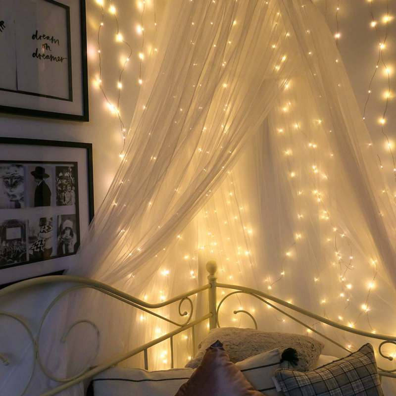 A beautiful room lit up in a festive, fairy lights aesthetic. Wallpaper
