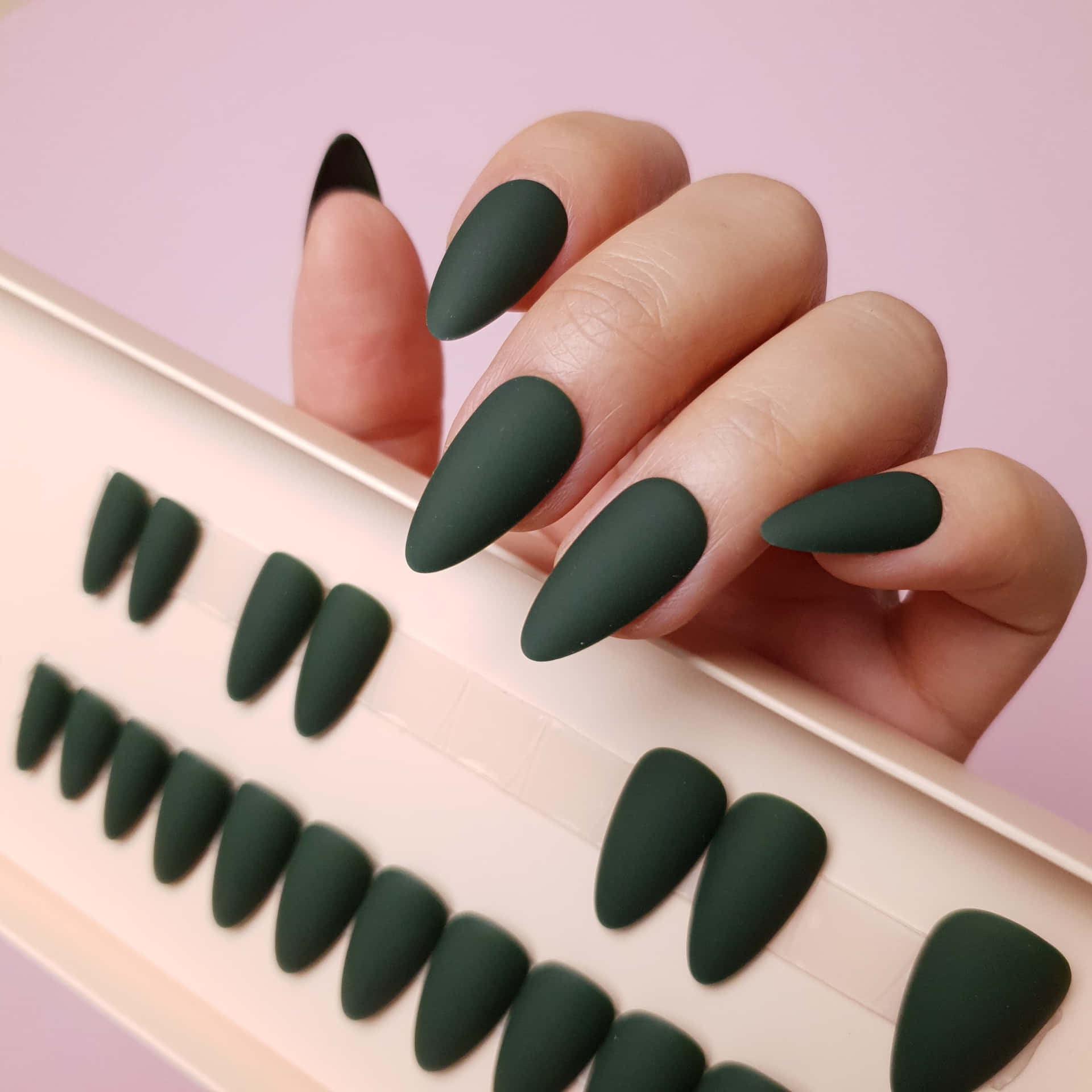 A Woman Holding A Box Of Green Nails