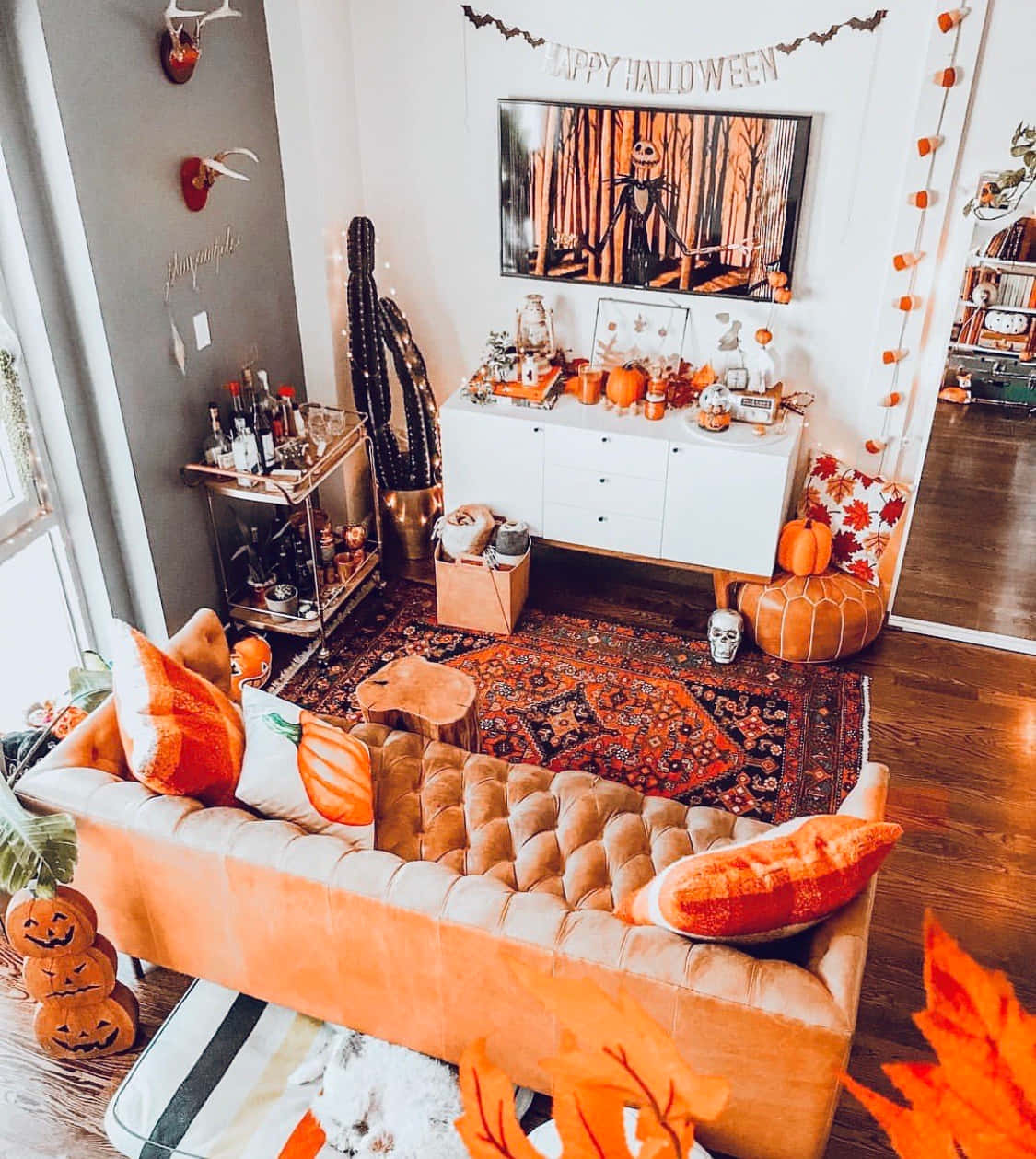A Living Room Decorated For Halloween With Orange Pumpkins And Orange Decor
