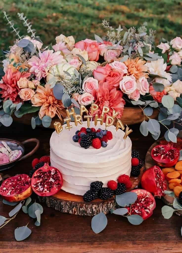 A Cake With Flowers And Fruit On Top Wallpaper