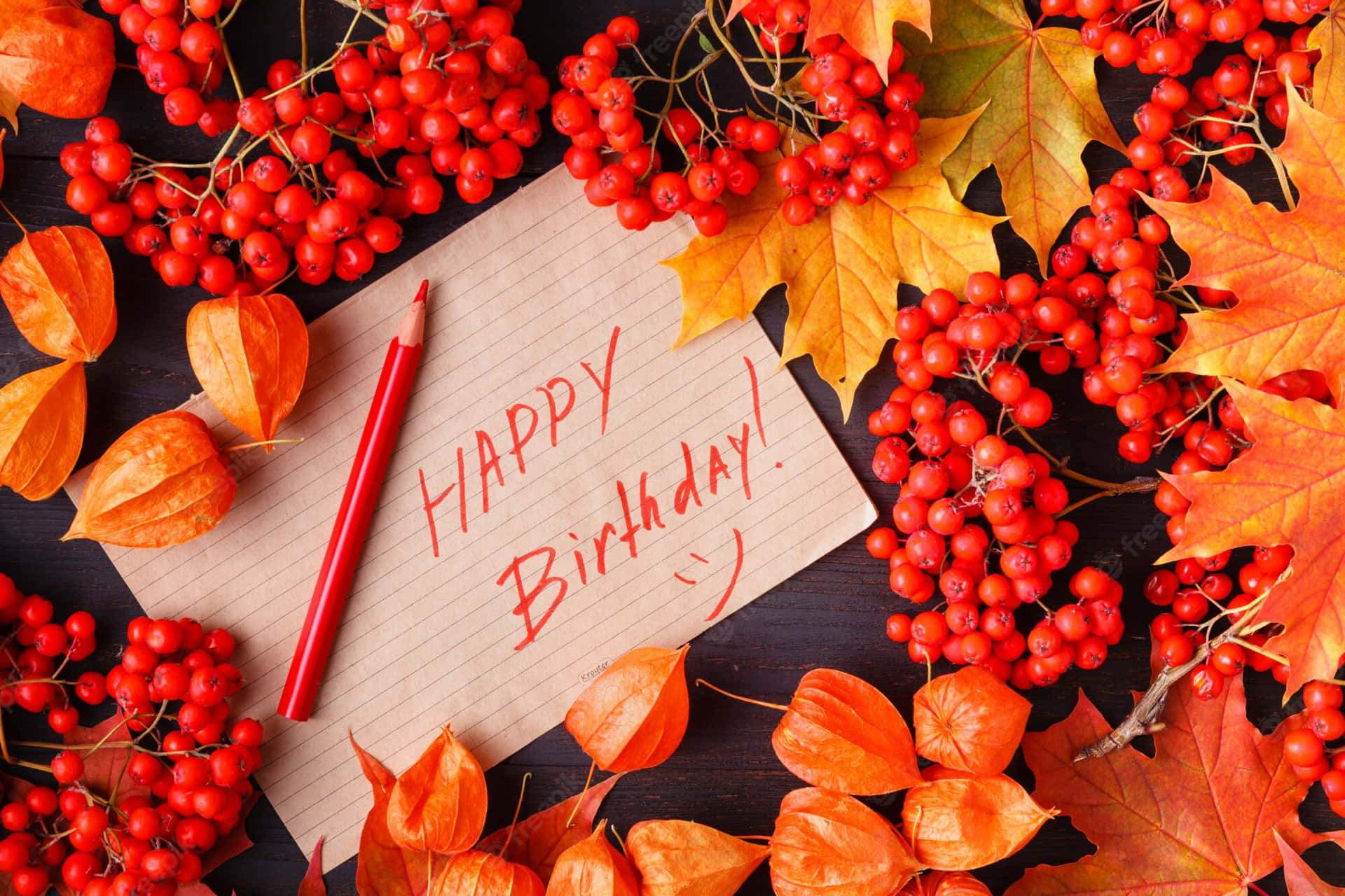 Happy Birthday Card With Red Berries And A Red Pen Wallpaper