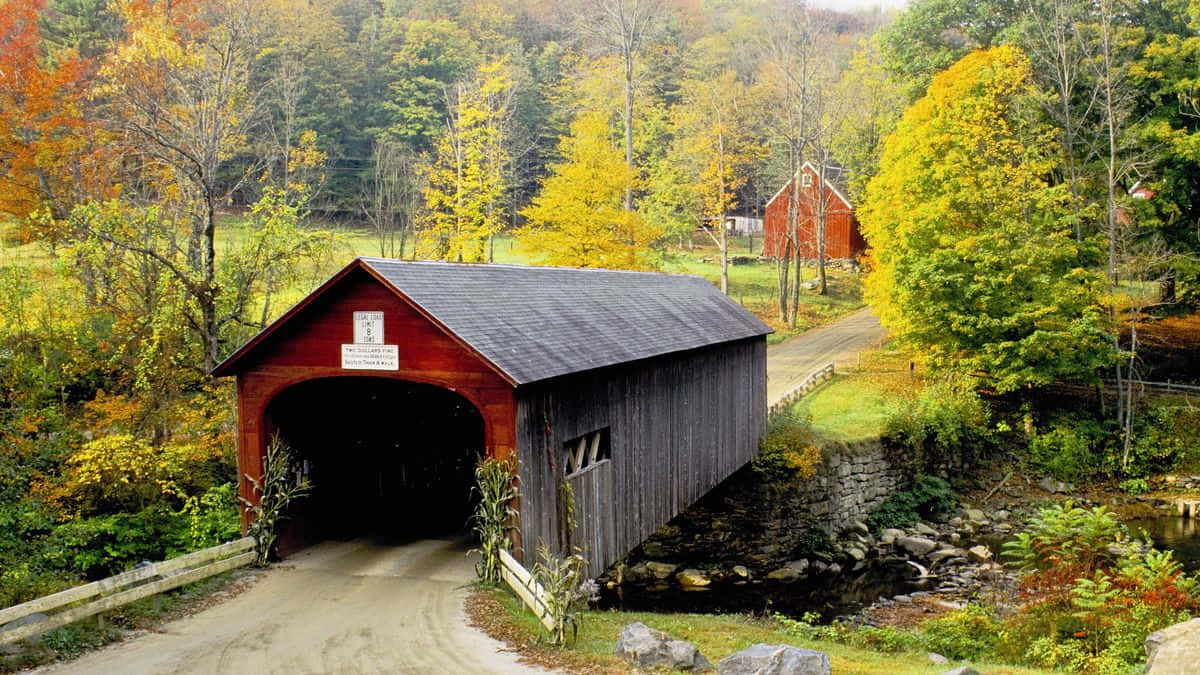 Enchanting Fall Bridge Amidst Autumn Splendor Wallpaper
