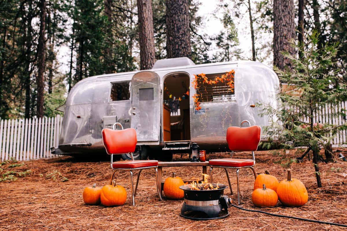 Cozy Fall Camping Scene with a Majestic Tent Wallpaper