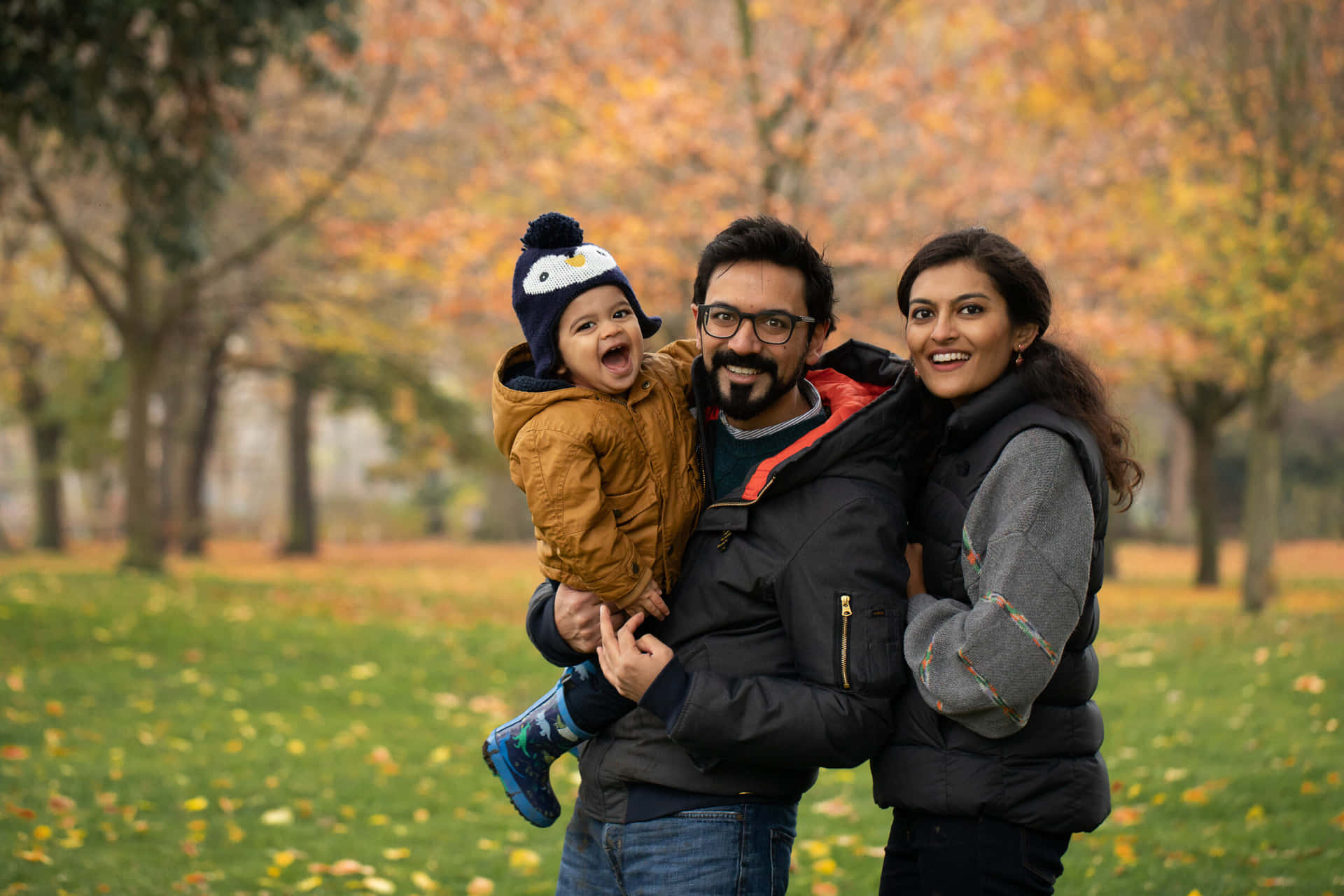 A Family Poses For A Photo In The Park