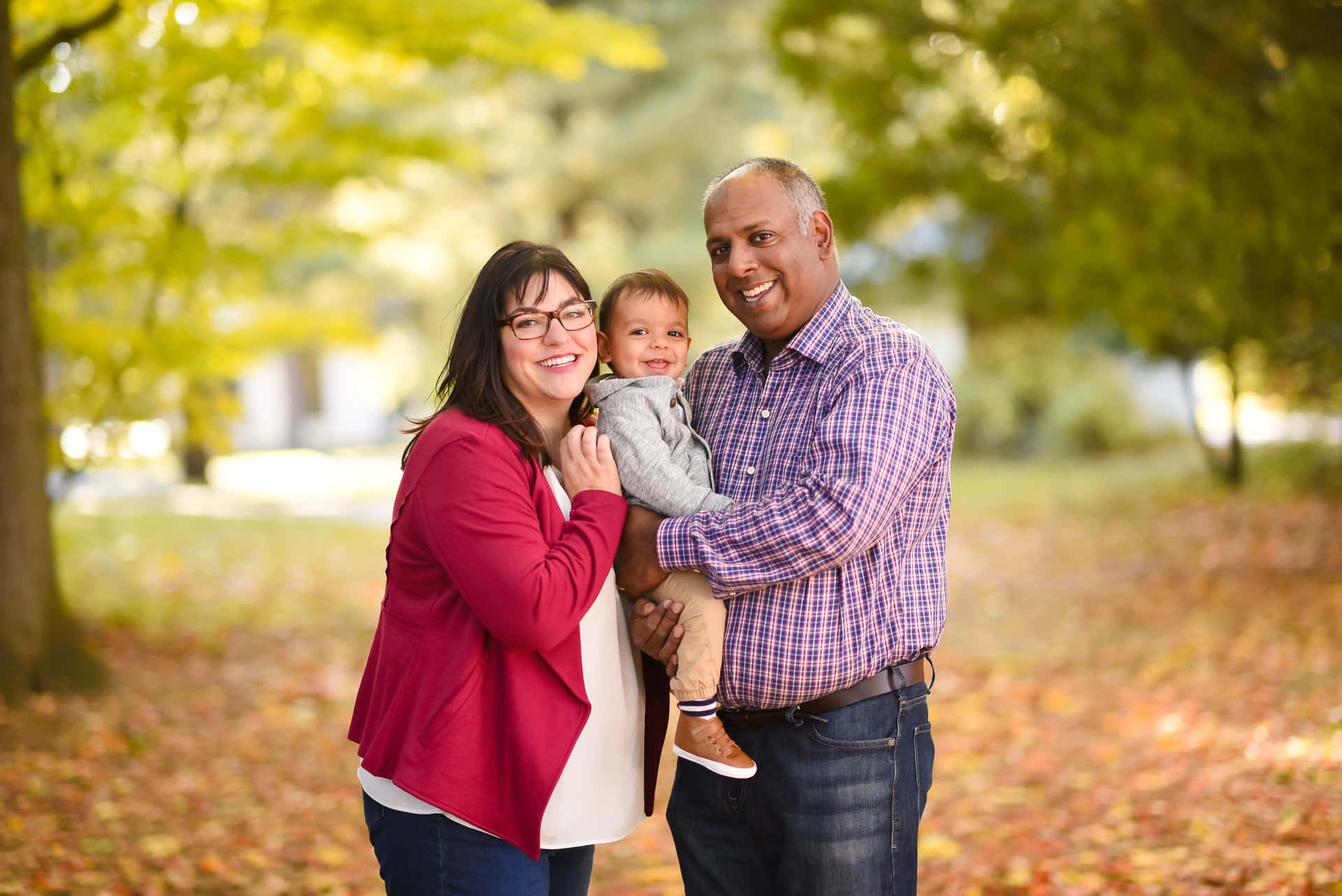 A Family Poses For A Photo In The Fall