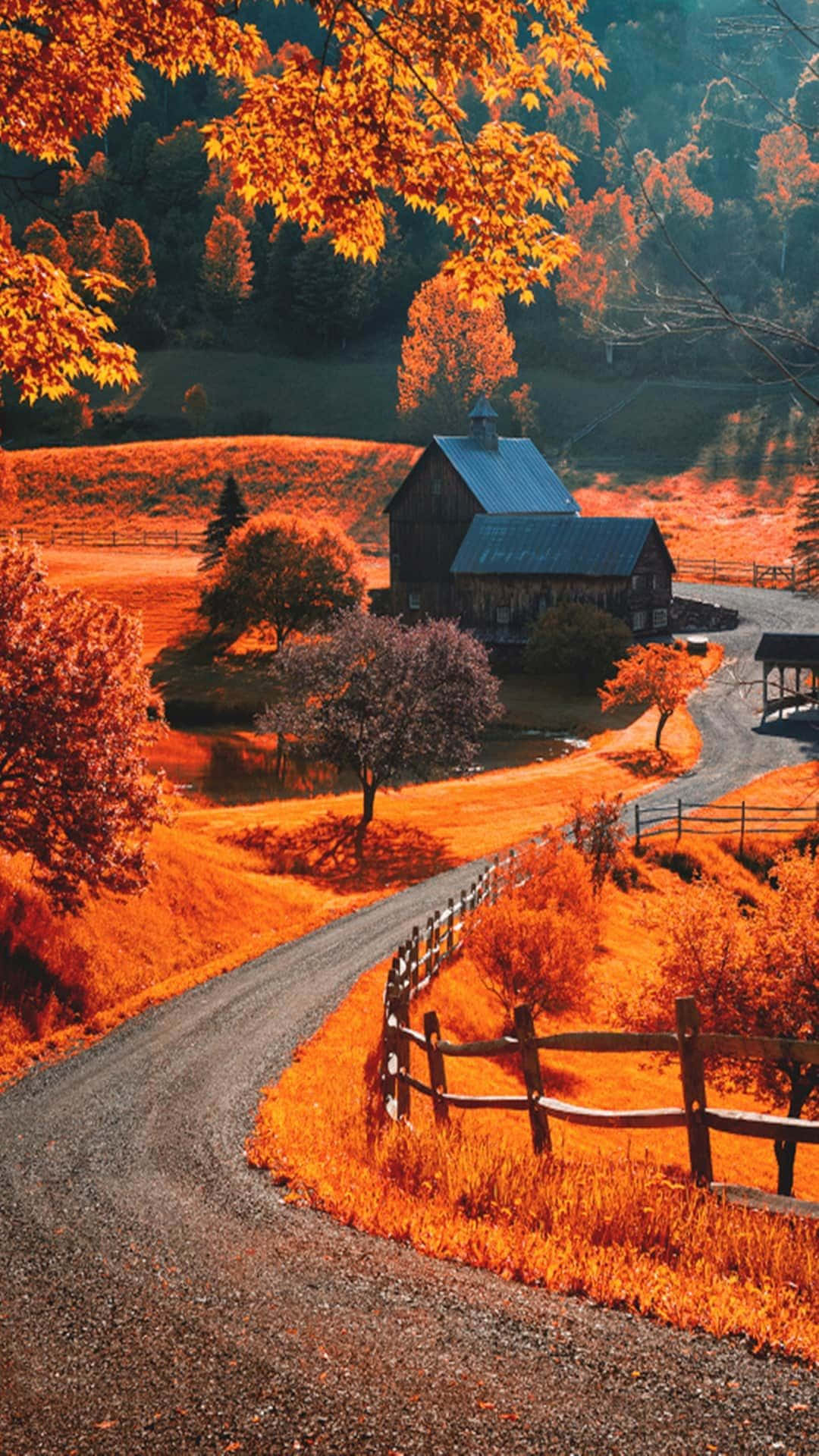 Enchanting Fall Farmhouse Amidst Vibrant Colors Wallpaper