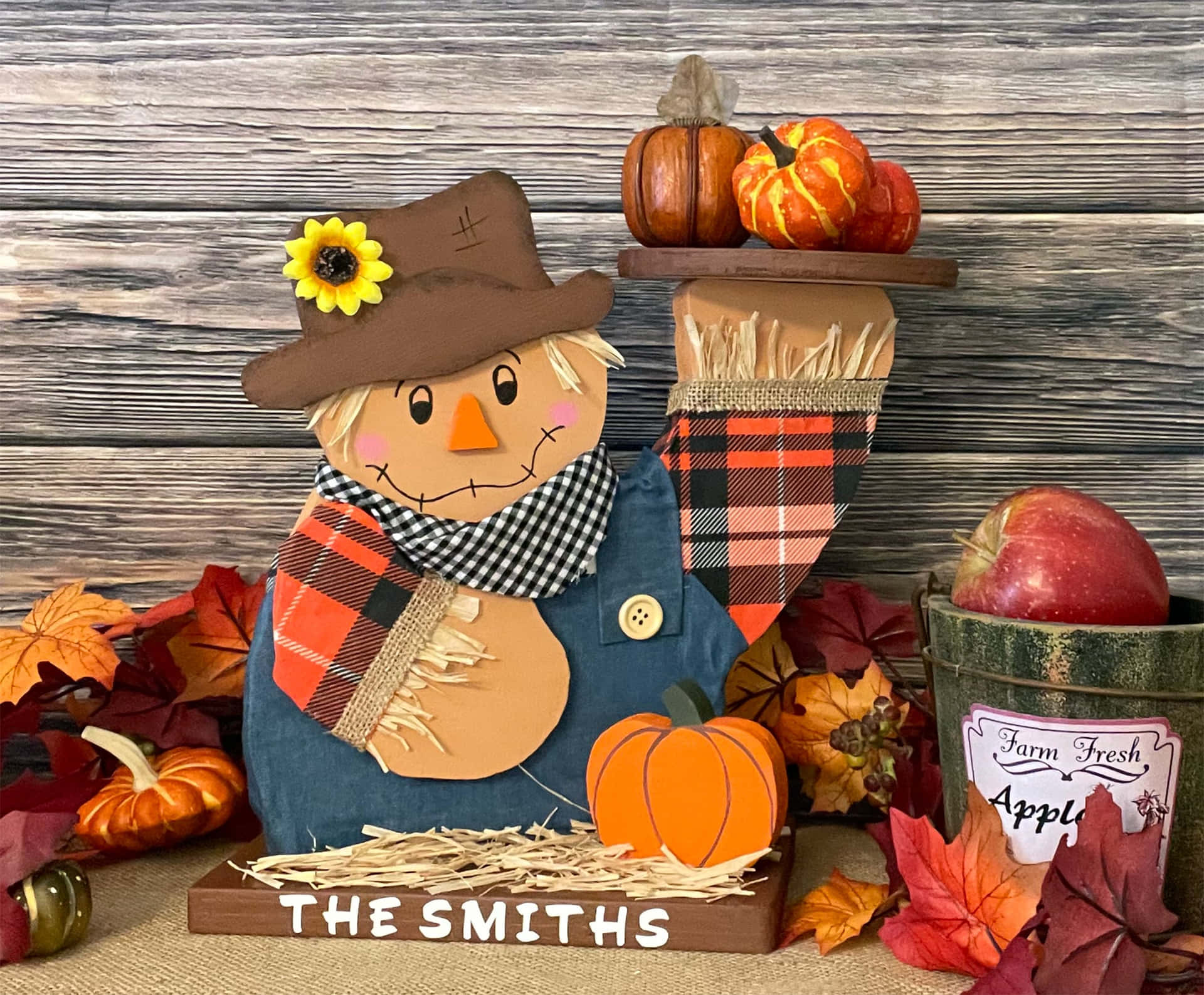 Vibrant Fall Scarecrow amidst Autumn Landscape Wallpaper