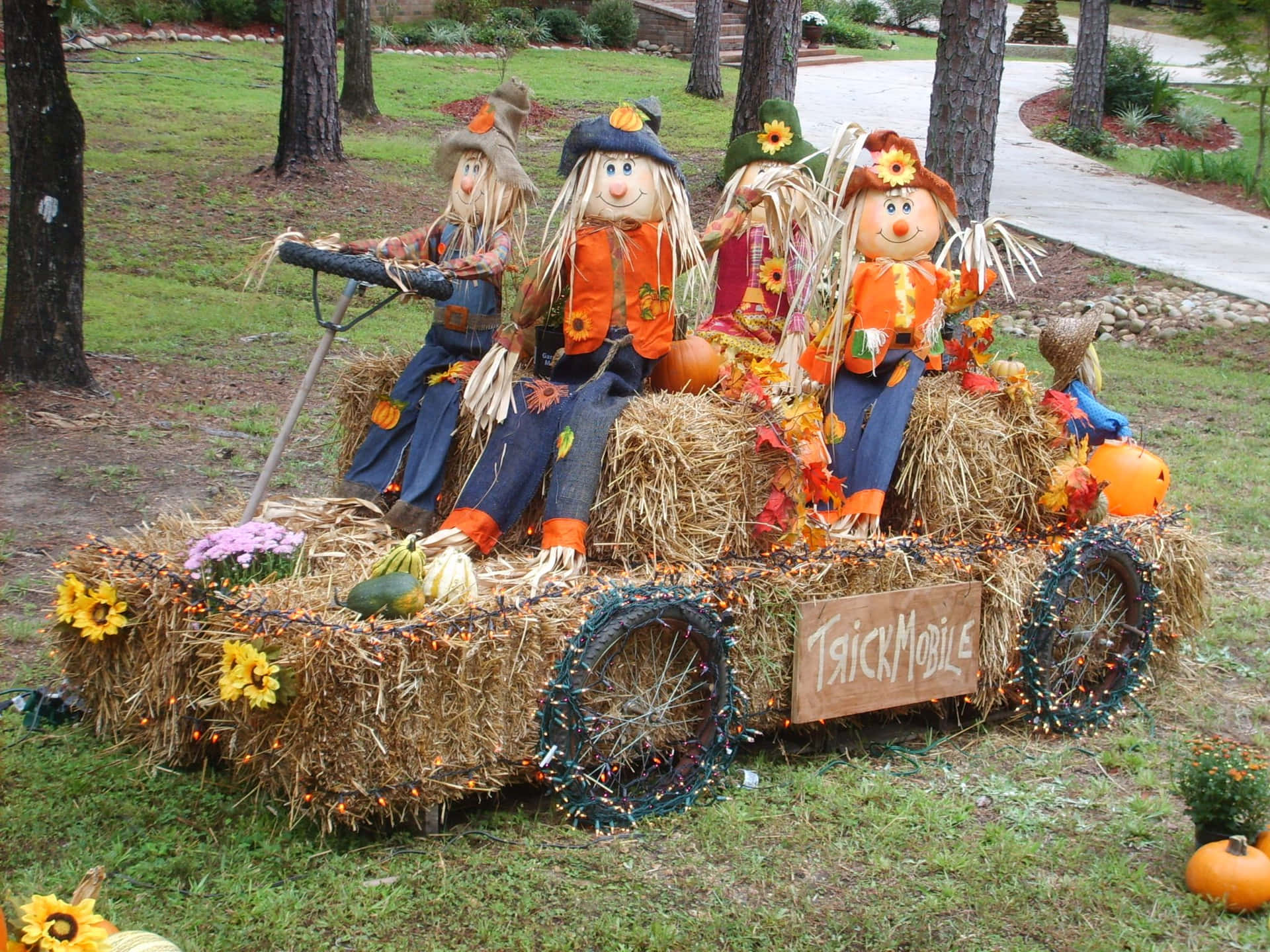 A Scenic Fall Scarecrow Display Wallpaper