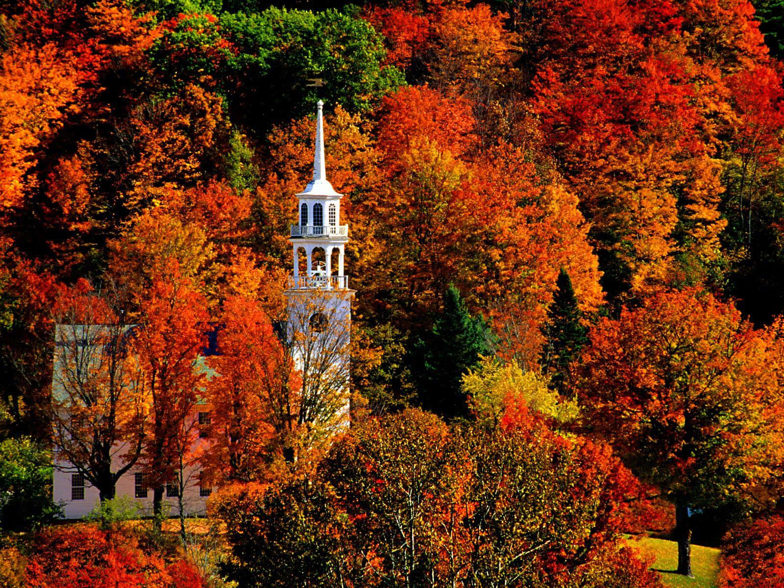 A picturesque Fall Town scene with colorful autumn leaves and charming architecture Wallpaper