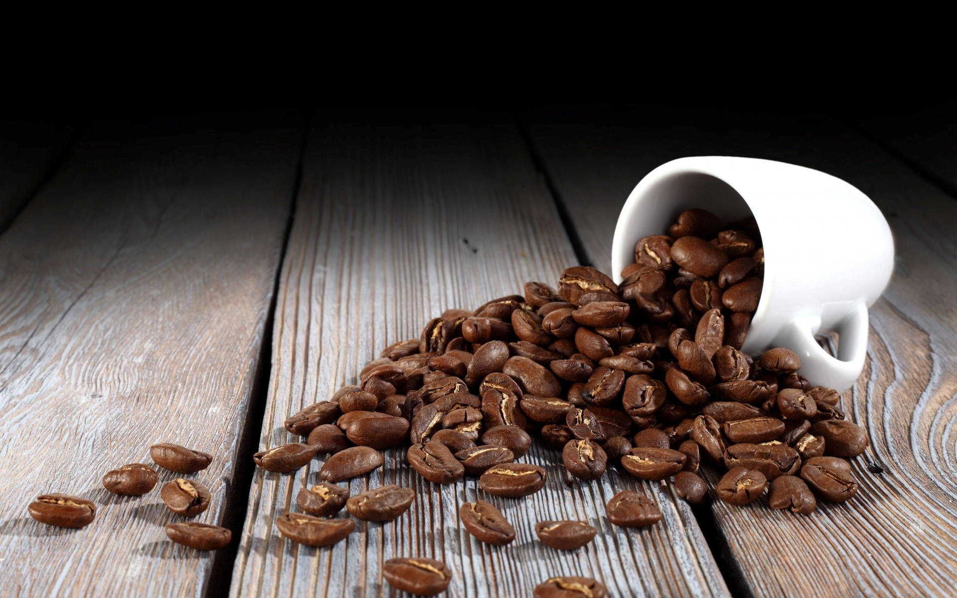 Fallen White Cup With Coffee Beans Wallpaper