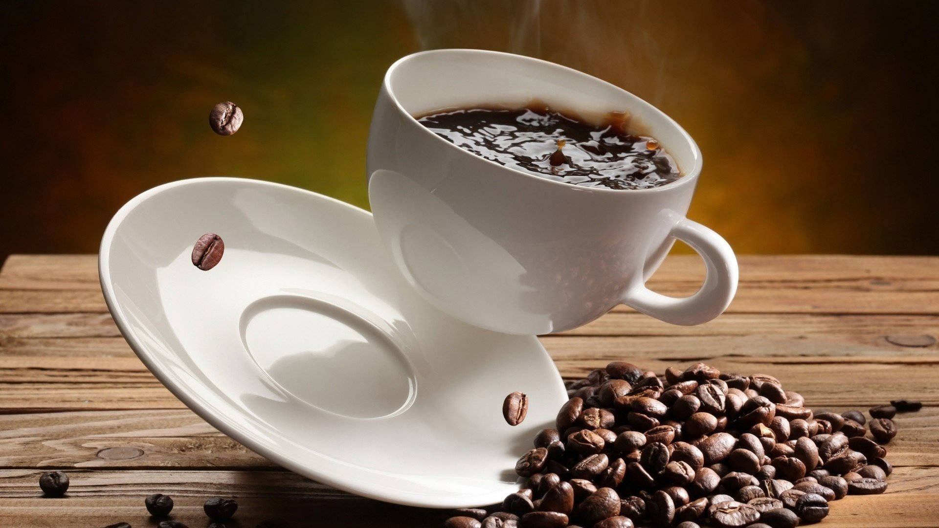 Falling Cup On Coffee Beans Wallpaper