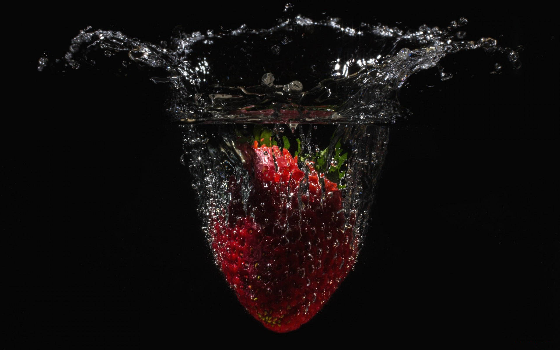 Download Falling Strawberry In Water Wallpaper 