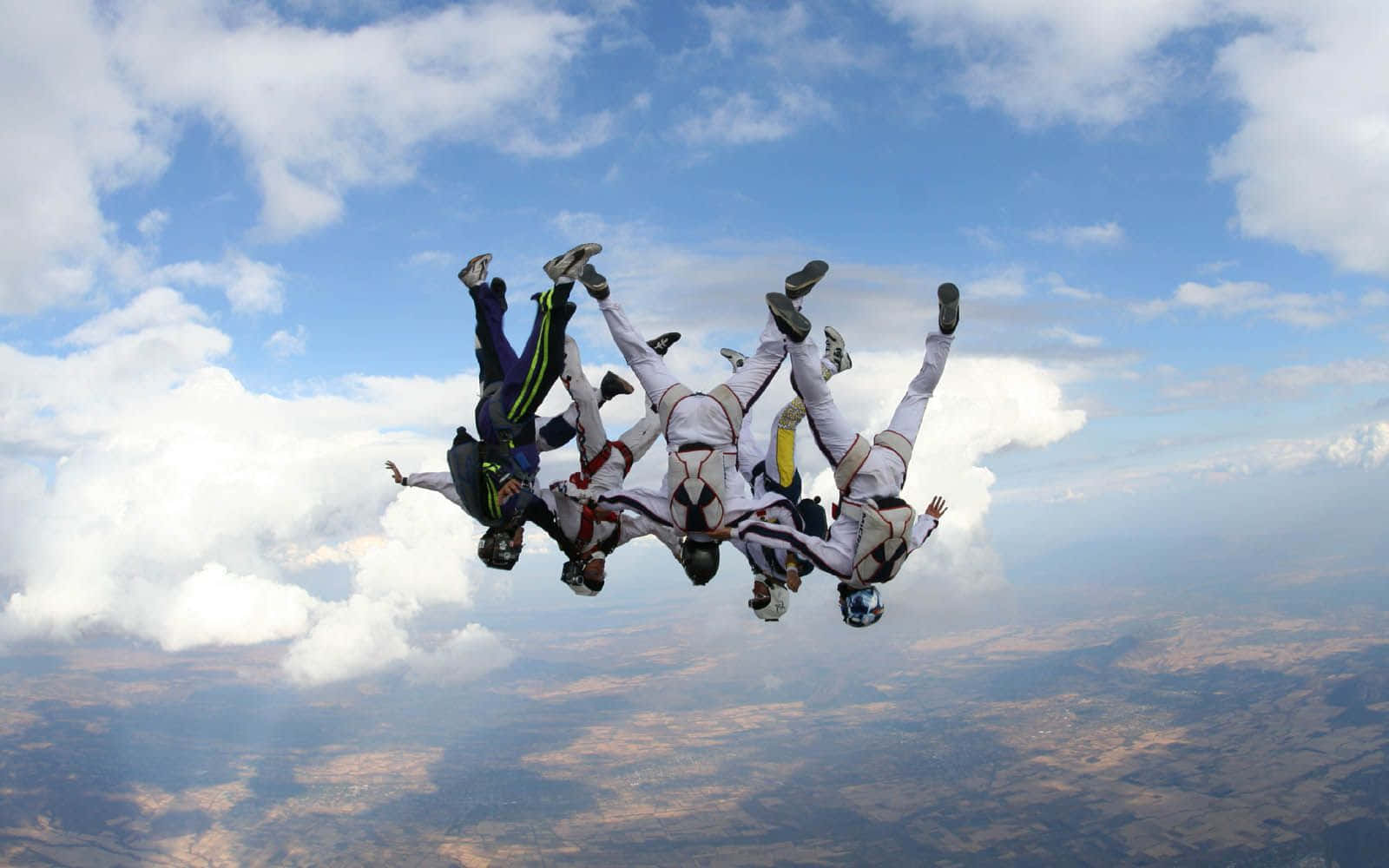 Experience The Thrill - Skydiving Upside Down Wallpaper