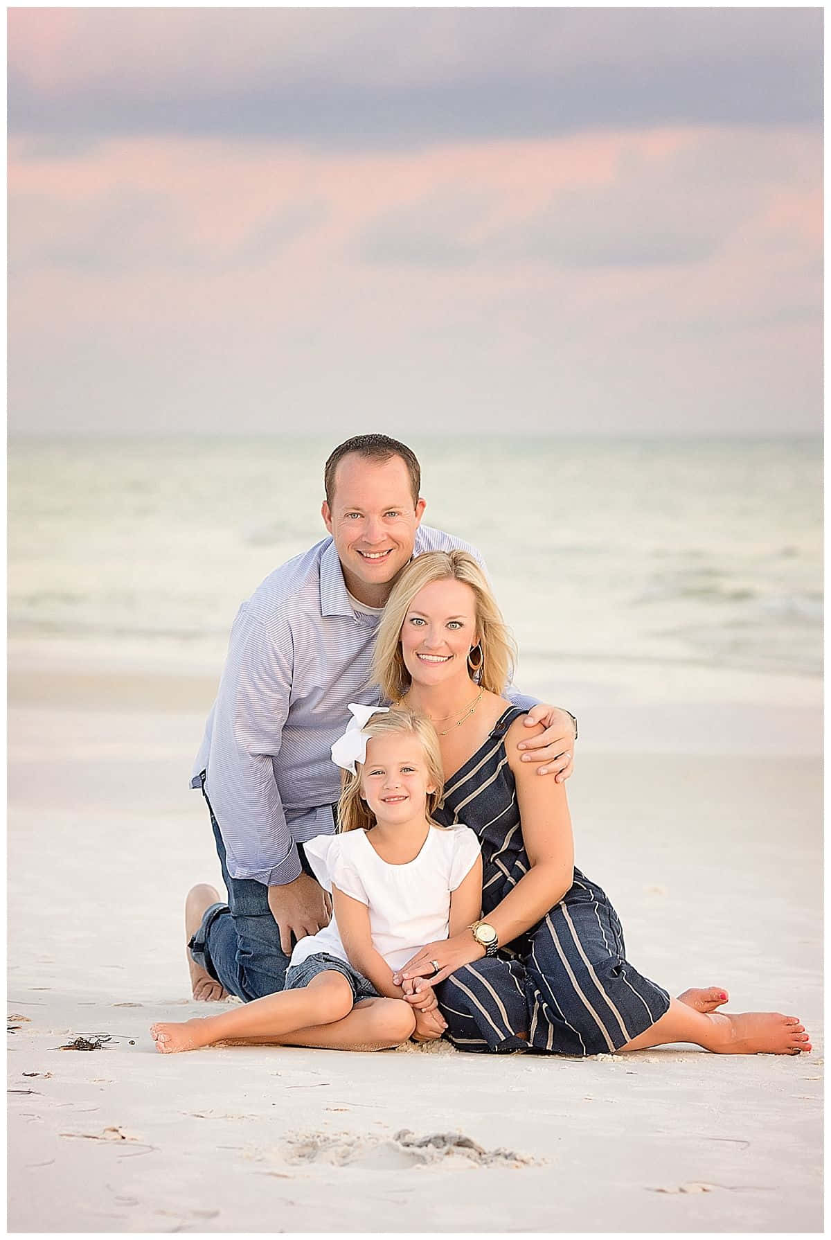 A Family Poses On The Beach For A Family Portrait