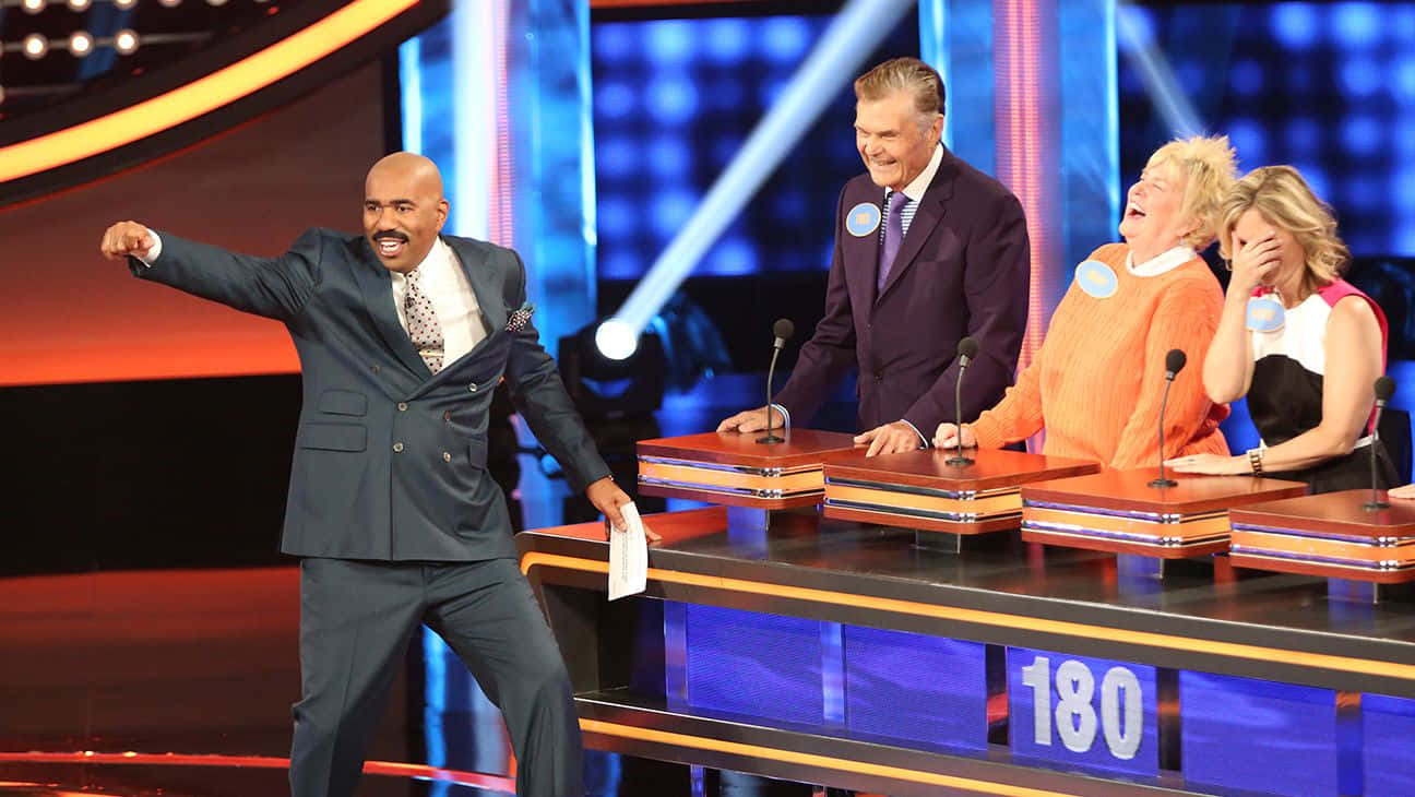 A Group Of People On Stage With A Man In A Suit