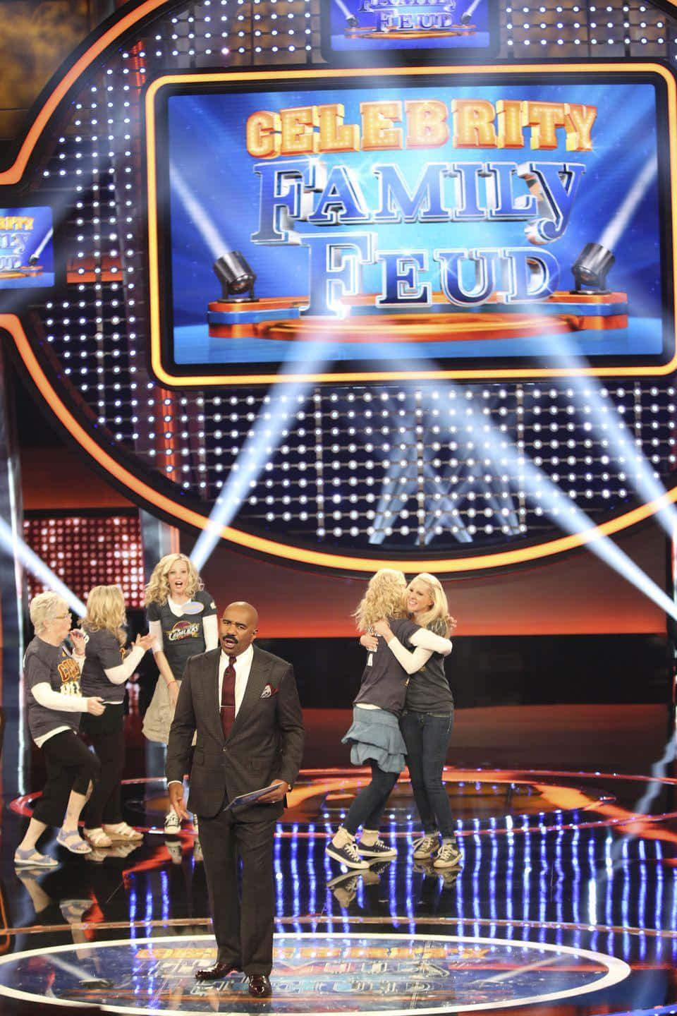 A Group Of People On Stage With A Sign That Says 'the Family Feud'