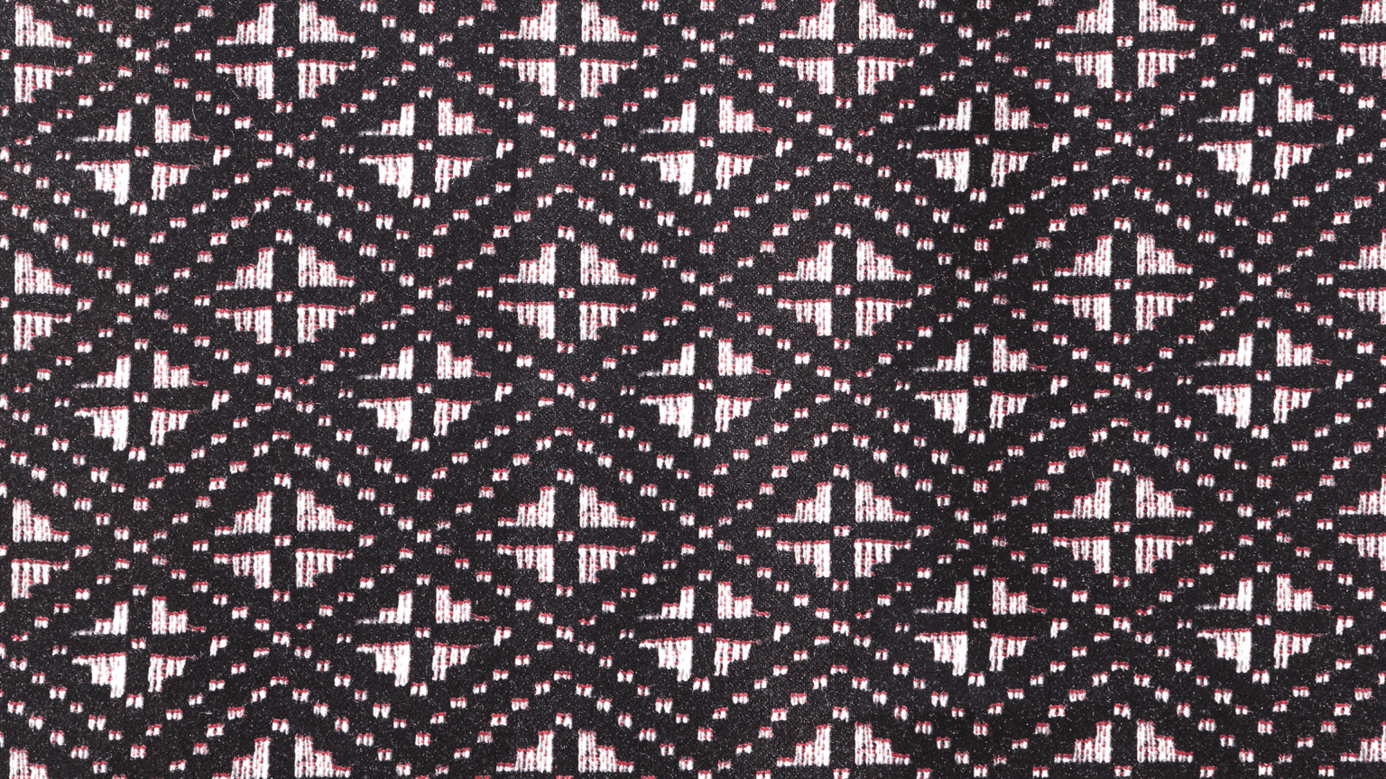 Geometric Pattern Fabric Texture Background — A close-up of a black fabric with a repeating geometric pattern in white and pink threads.