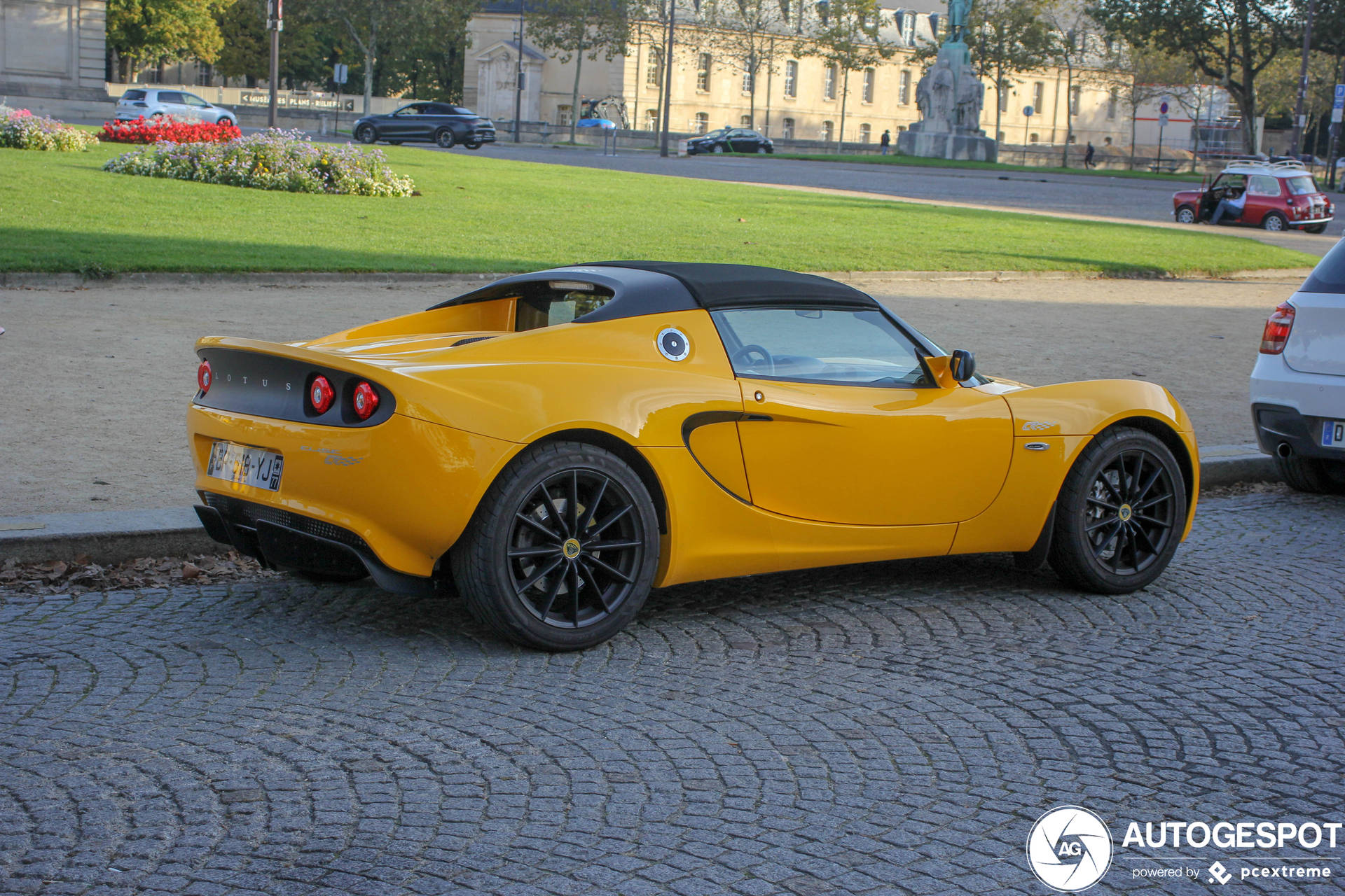 Fancy Yellow Lotus Car On The Streets Wallpaper