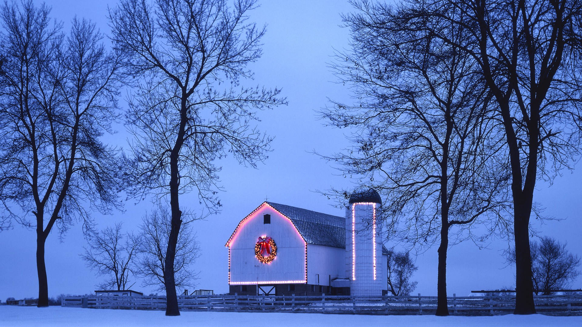 A Barn With A Christmas Tree In The Snow Wallpaper