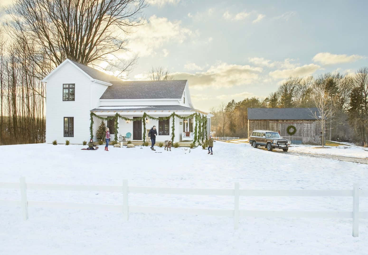 A White Farmhouse With A Snow Covered Yard Wallpaper