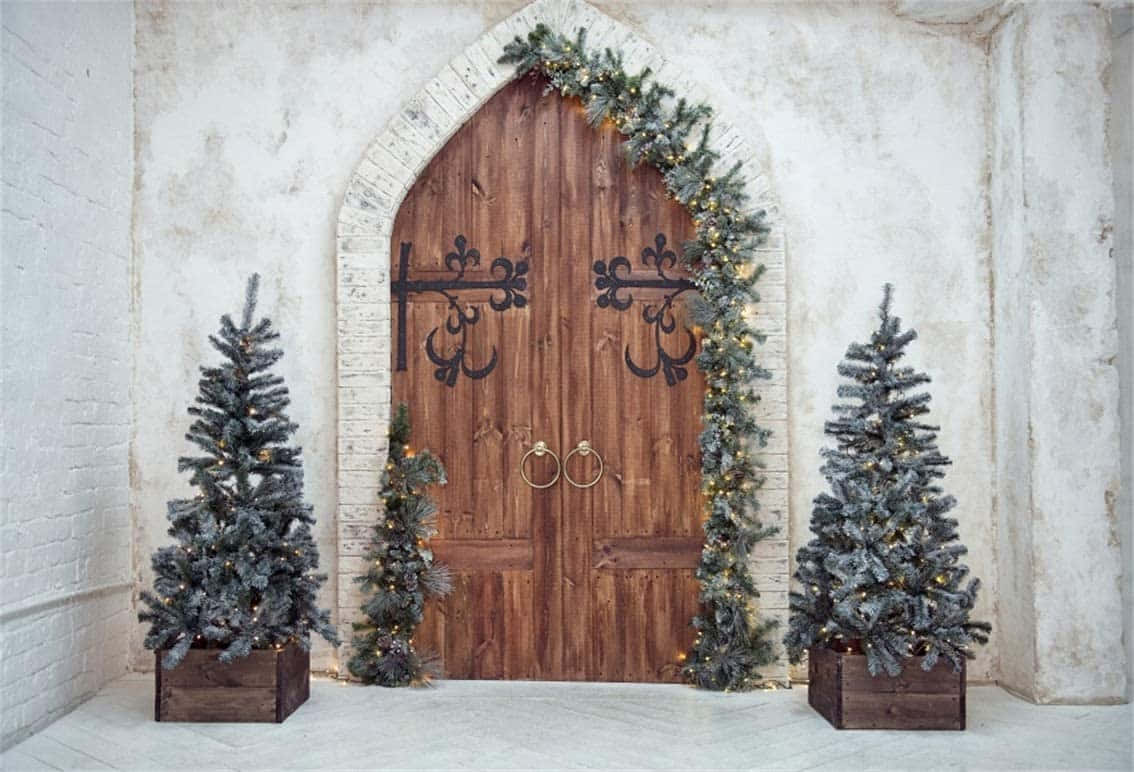 A Wooden Door With Two Christmas Trees In Front Of It Wallpaper