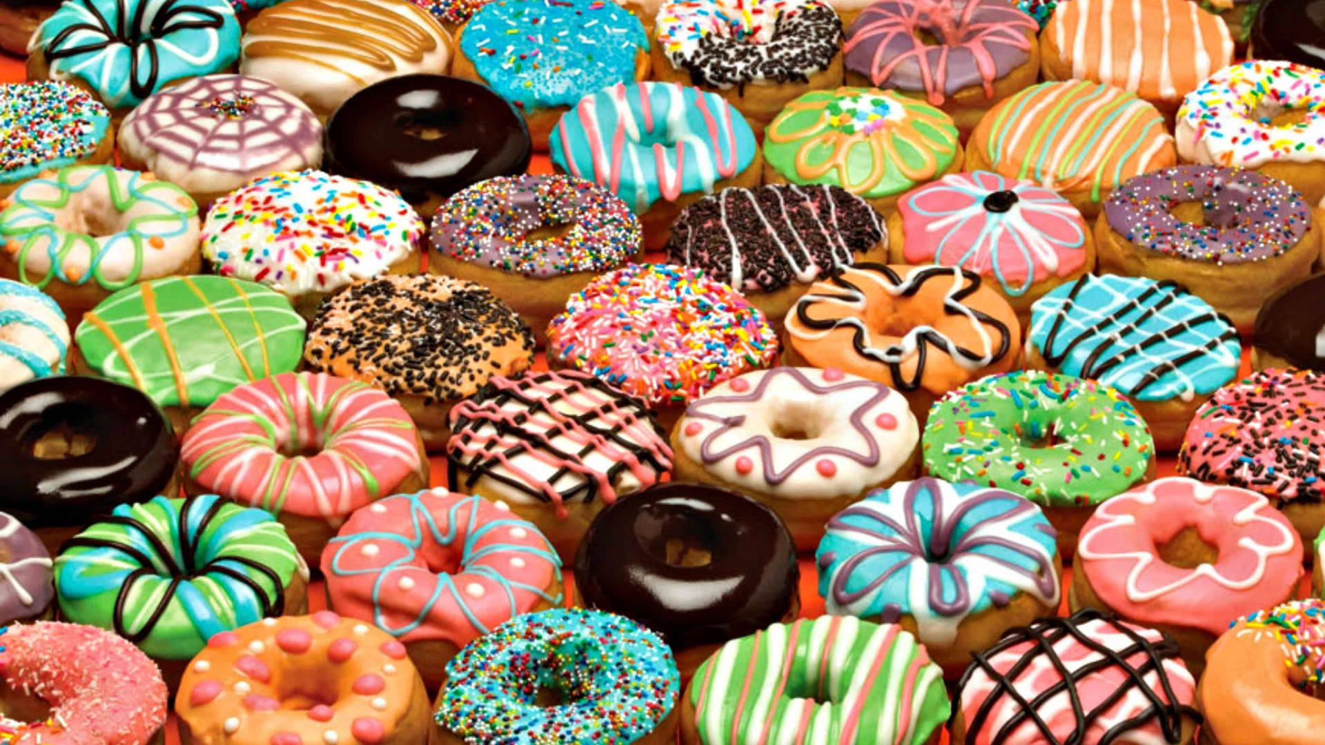 Farverige Donuts Med Forskellige Smagsstoffer Wallpaper