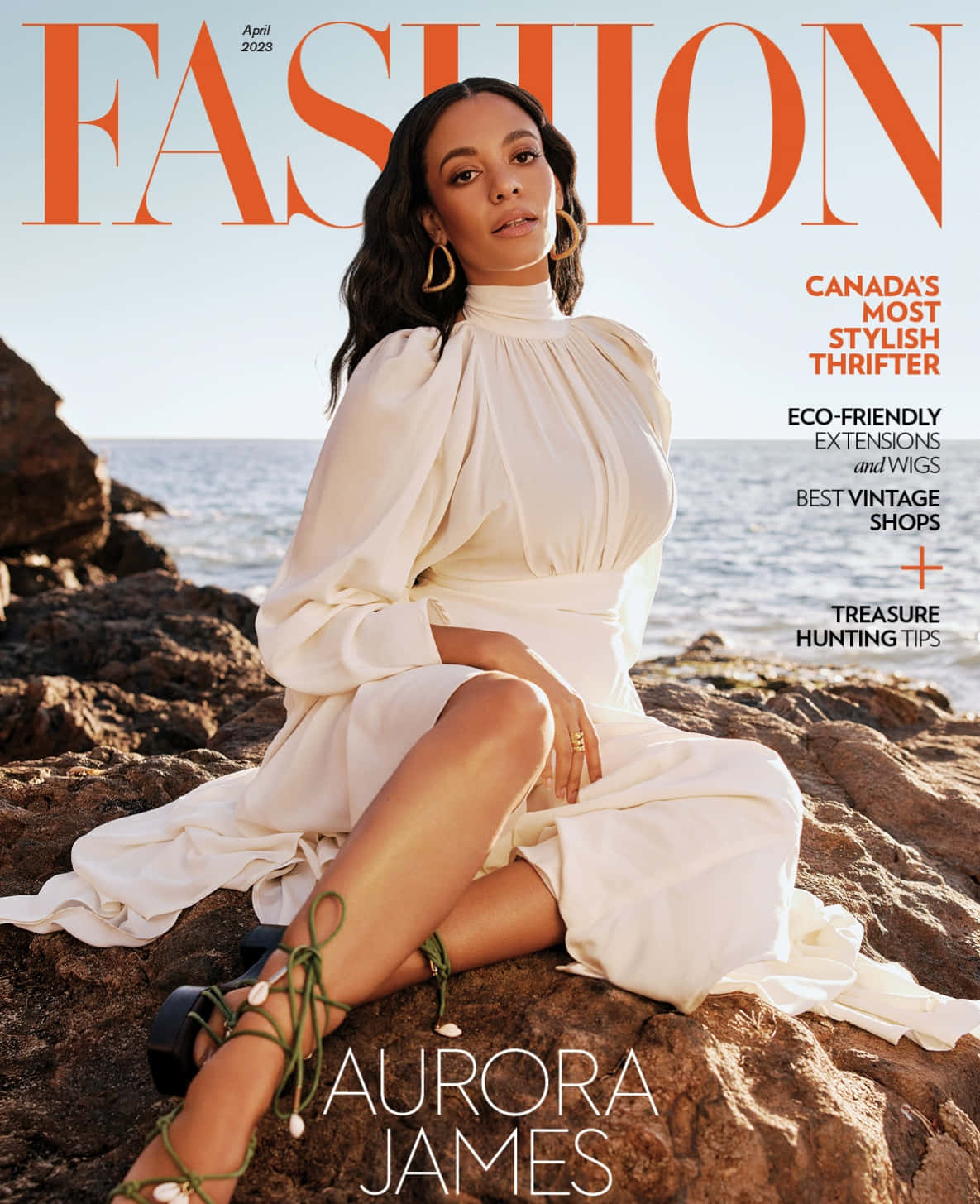 A Woman In White Sitting On Rocks On The Cover Of Fashion Magazine