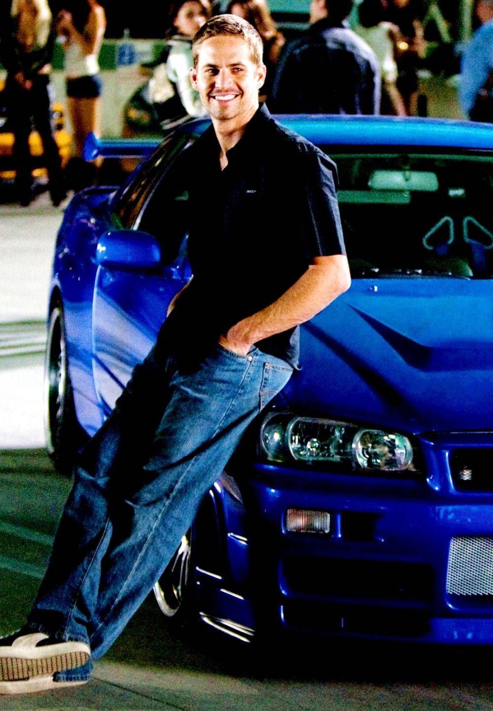 A Man Leaning On A Blue Sports Car Wallpaper