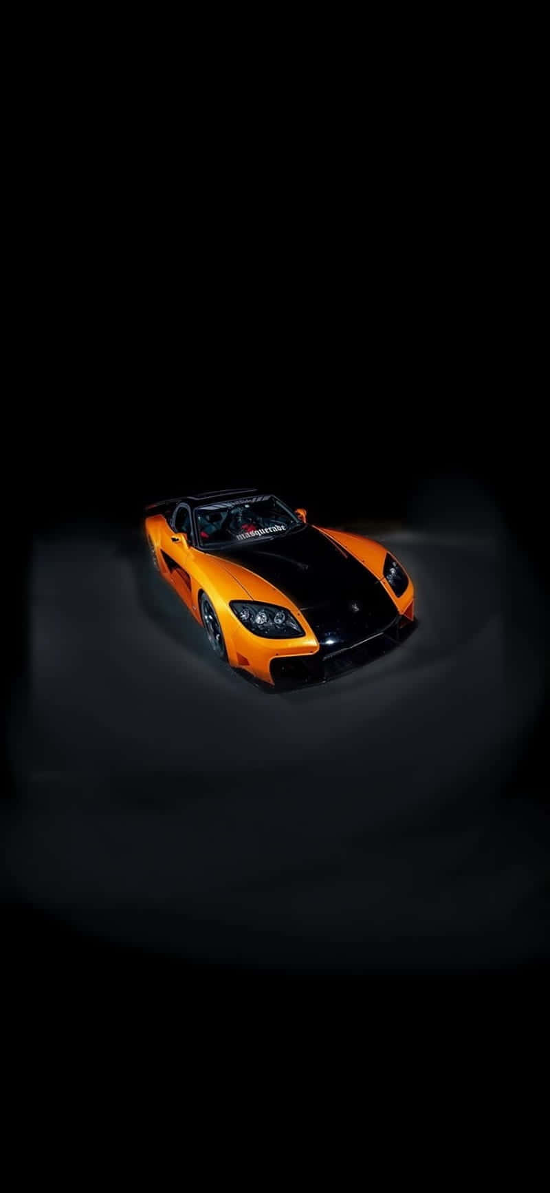A Black And Orange Sports Car In The Dark Wallpaper