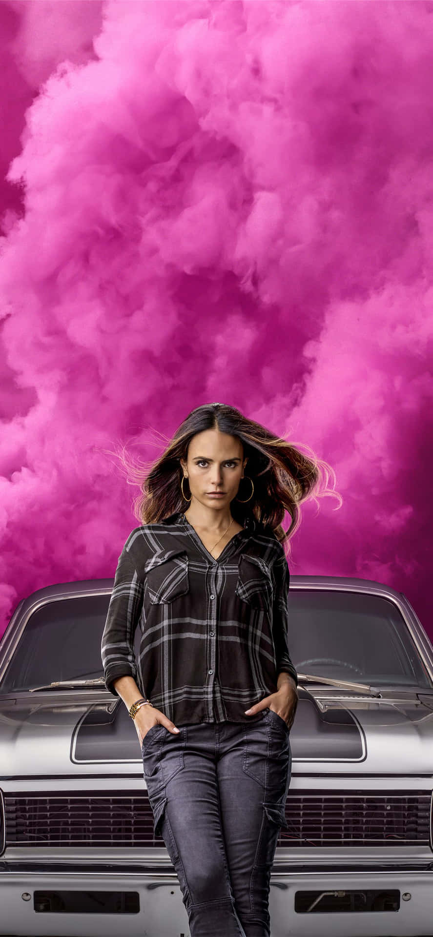 A Woman Standing Next To A Car With Pink Clouds Wallpaper