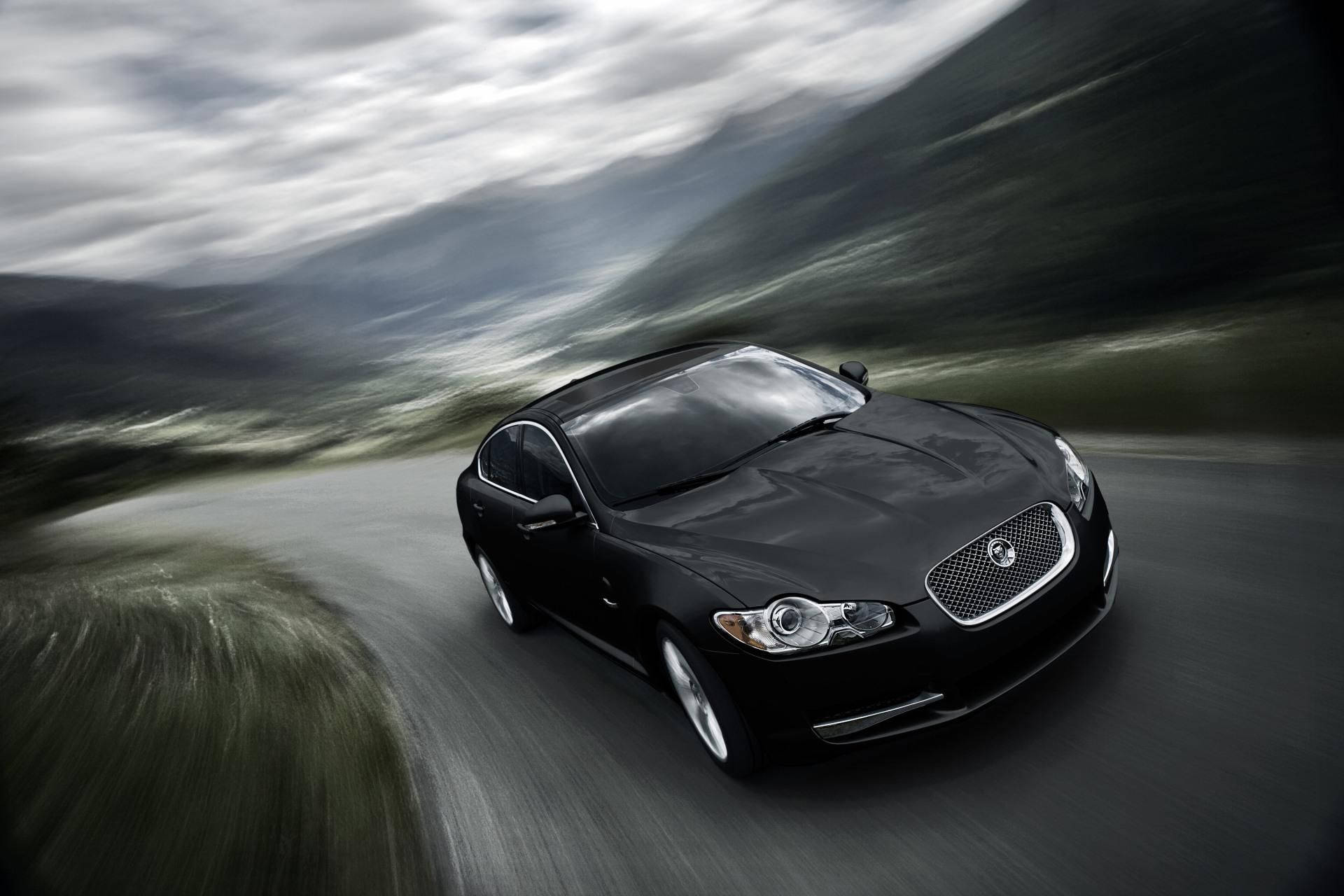 Speed and style combine in this sleek black Jaguar car. Wallpaper