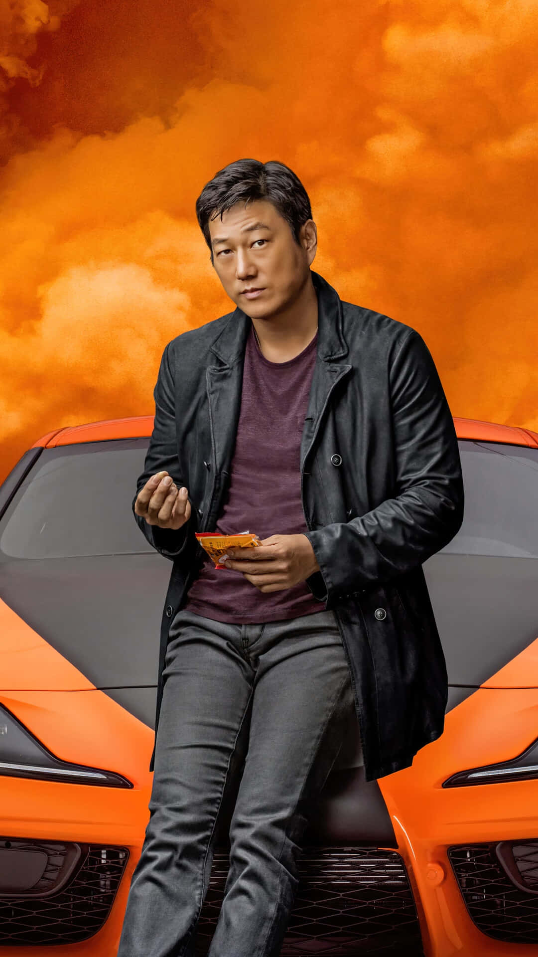 A Man Sitting On Top Of A Sports Car Wallpaper