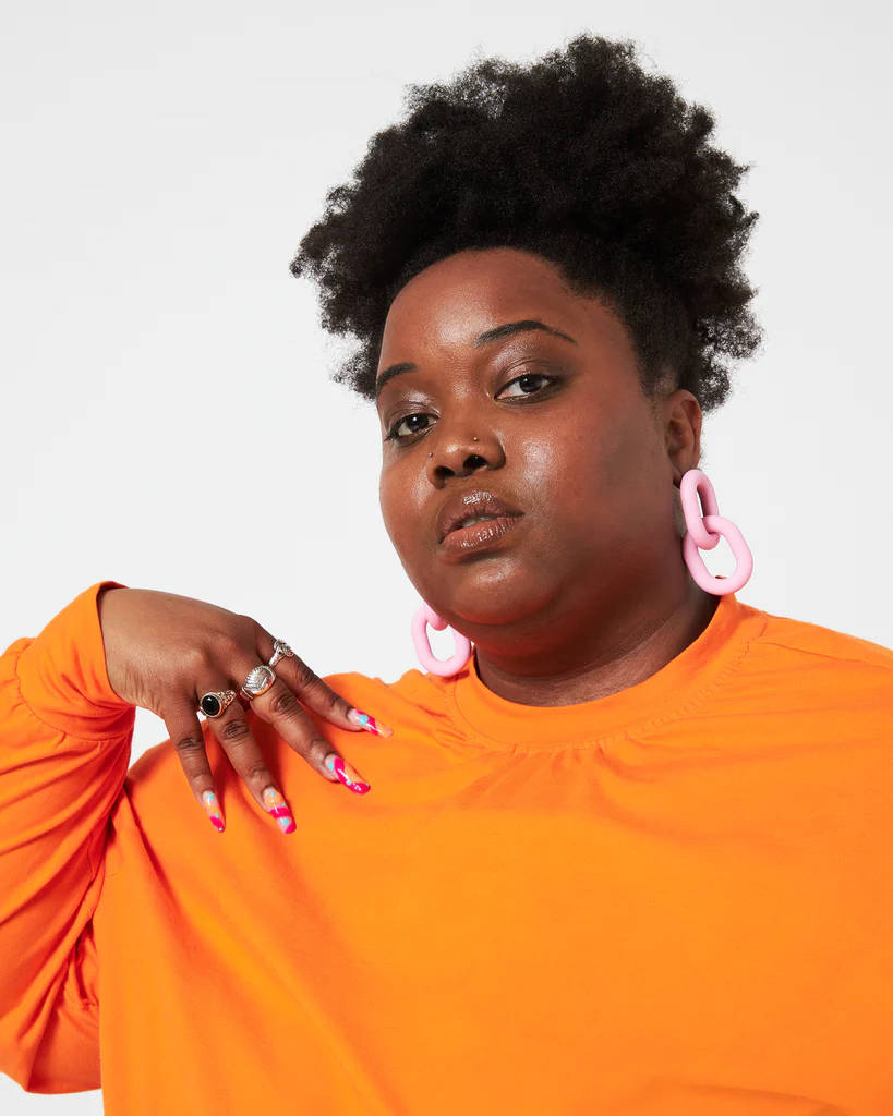 Download Fat Black Woman In Orange Wallpaper