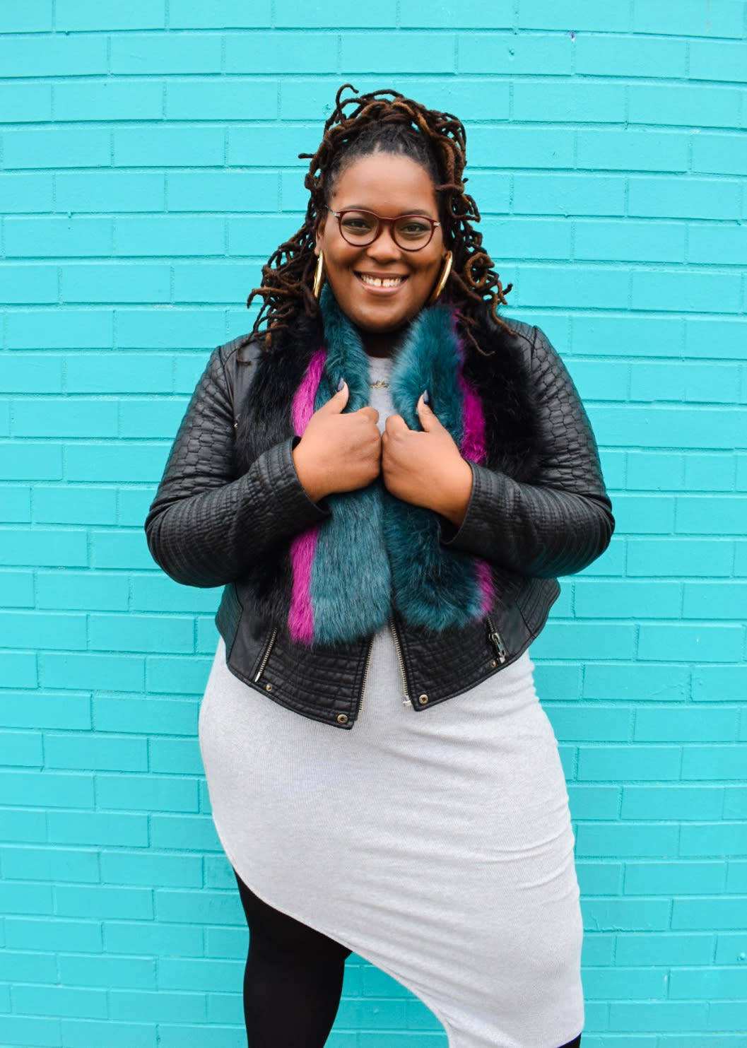 Confident Black Woman Embracing Her Curves in a Teal Background Wallpaper
