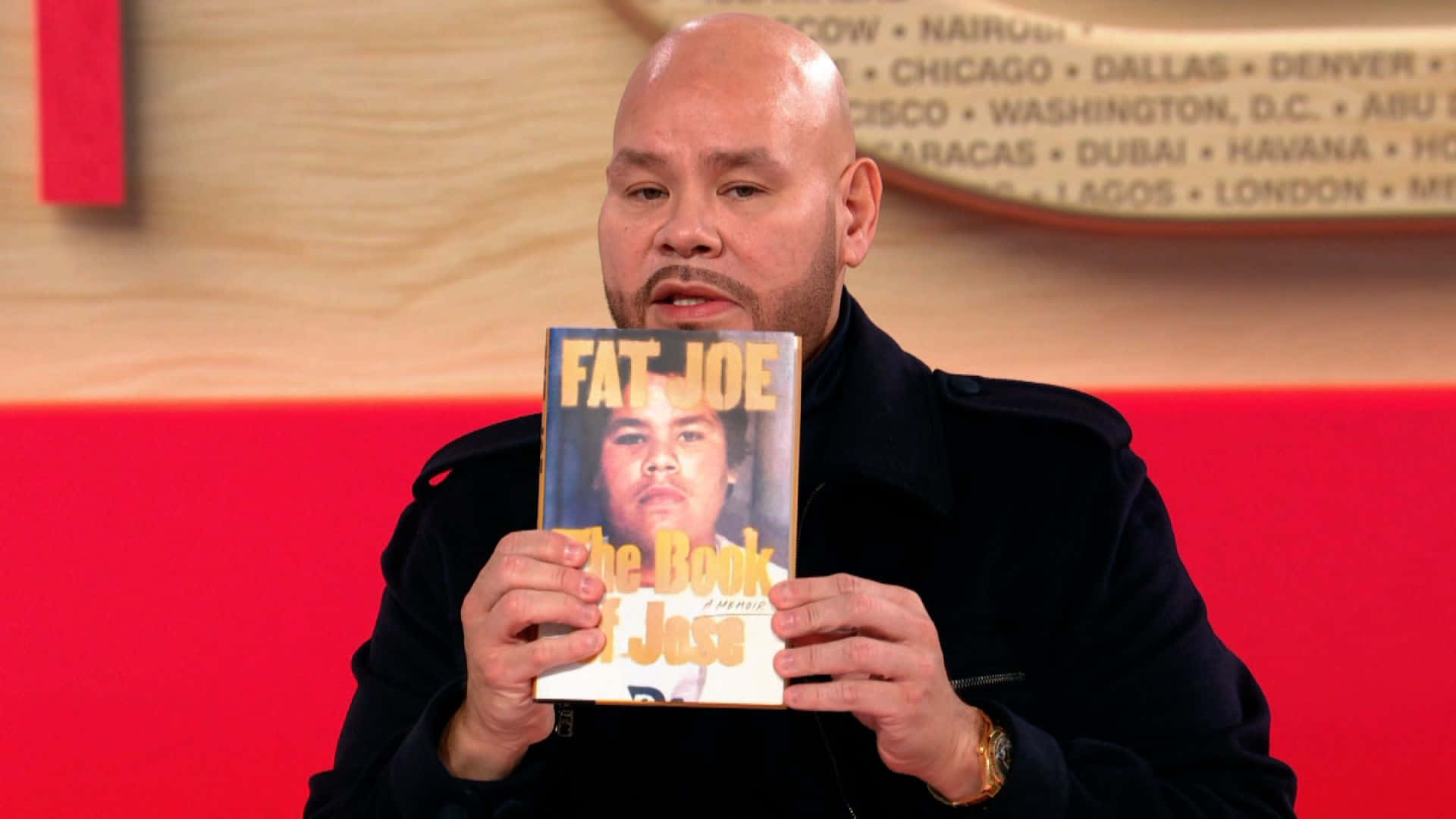 Fat Joe Holding His Book Wallpaper