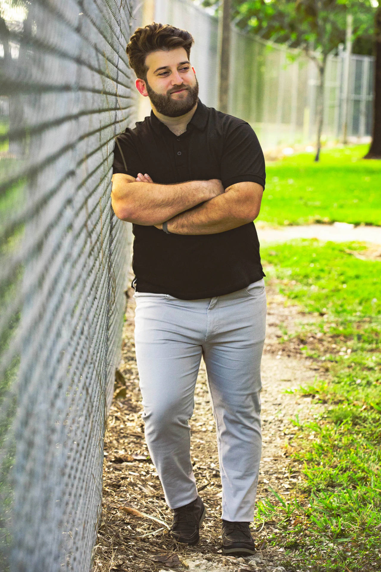 Fat Person Posing By Fence Wallpaper