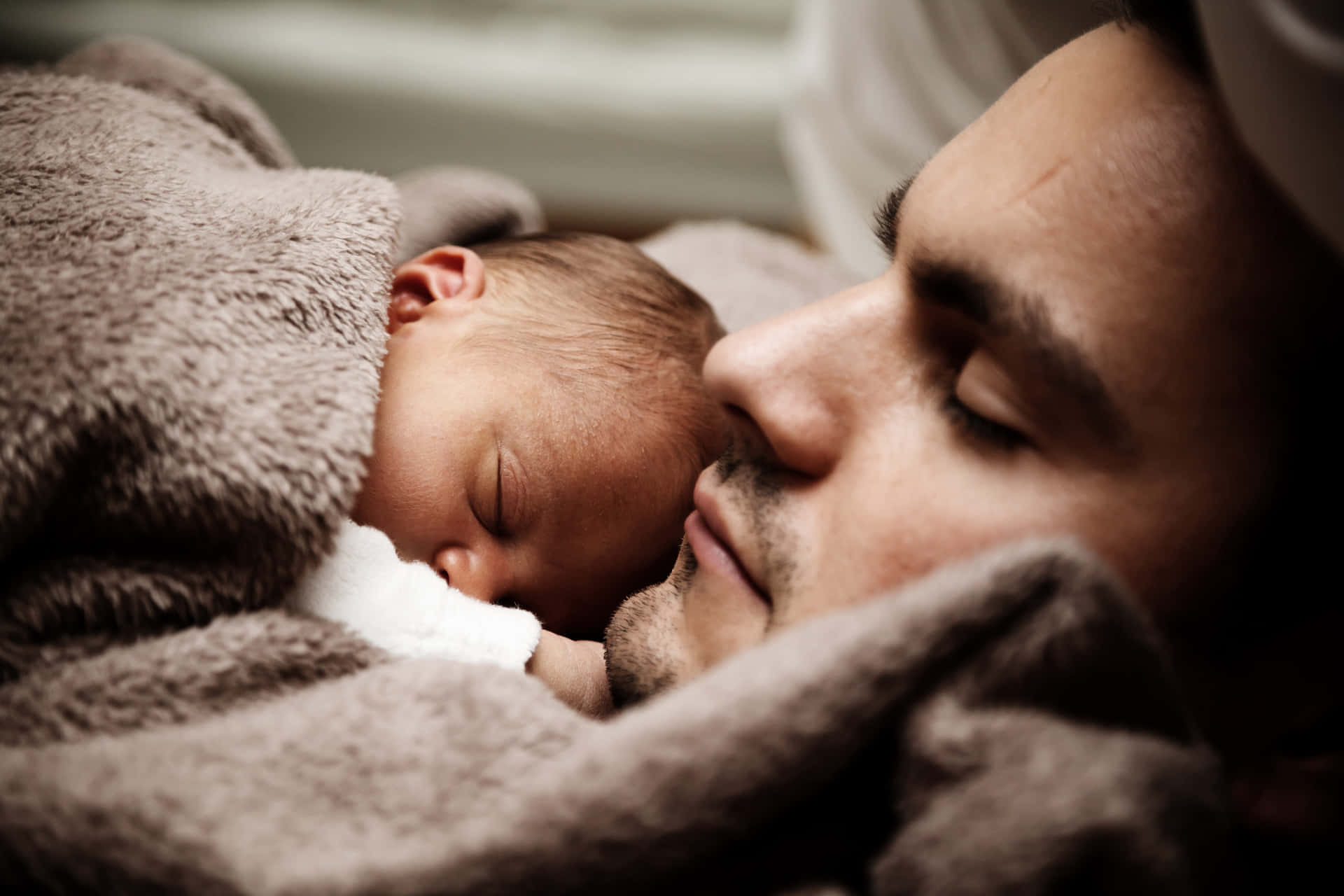 Father Sleeping With A Newborn Child Wallpaper