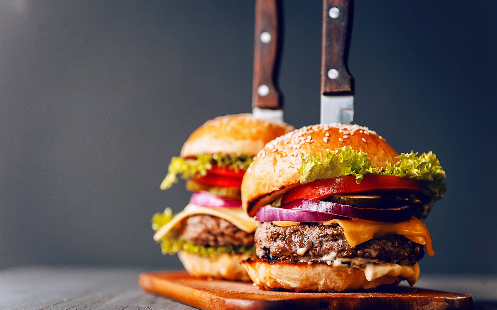 Fatty Cheeseburgers Pierced With Knives Wallpaper