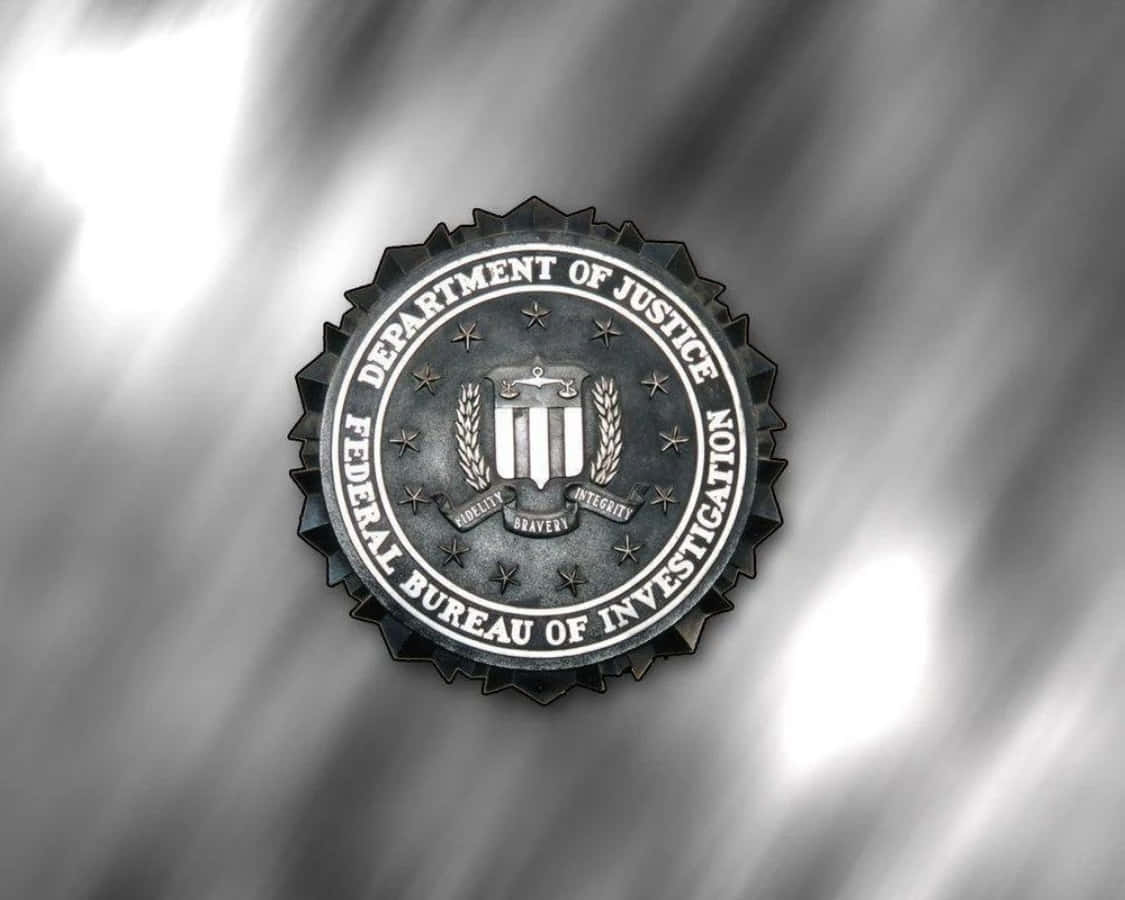 The Fbi Logo Is Shown On A Silver Background